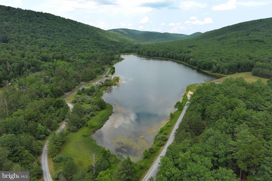 THE CREATION OF YOUR "MOUNTAIN LAKE RETREAT" COULD BEGIN HERE.  THIS 3+ ACRE TRACT IS LOCATED  AN EASY WALK AWAY FROM THE 44 ACRE WARDEN LAKE, WHICH IS A STATE MANAGED PUBLIC LAKE, IN THE MOUNTAINS JUST OUTSIDE OF THE QUAINT, SMALL TOWN OF WARDENSVILLE, WV.  GENTLE TOPOGRAPHY WITH ACCESS BY ROADS AT TOP AND BOTTOM PROVIDE MANY POSSIBILITIES FOR FUTURE CONSTRUCTION.  LESS THAN A 45 MINUTE DRIVE FROM I-81 AT STRASBURG, VA WILL PUT YOU IN THE HEART OF ALL THAT WEST VIRGINIA HAS TO OFFER.  EVERYTHING FOR THE OUTDOOR ENTHUSIAST CAN BE FOUND HERE.   WITHIN MINUTES OF THE PROPERTY ARE OPPORTUNITIES FOR FISHING AND BOATING ON THE LAKE,  HIKING OR HUNTING IN THE GEORGE WASHINGTON NATIONAL FOREST, SHORT MOUNTAIN WMA, NATHANIAL MOUNTAIN WMA, OR TRAVEL A LITTLE FARTHER TO THE SOUTH AND WEST AND ENJOY THE LOST RIVER STATE PARK.  LAKE INFORMATION PROVIDED IN THE LISTING DOCUMENTS.  MAKE THE TRIP TO CHECK IT OUT SOON.