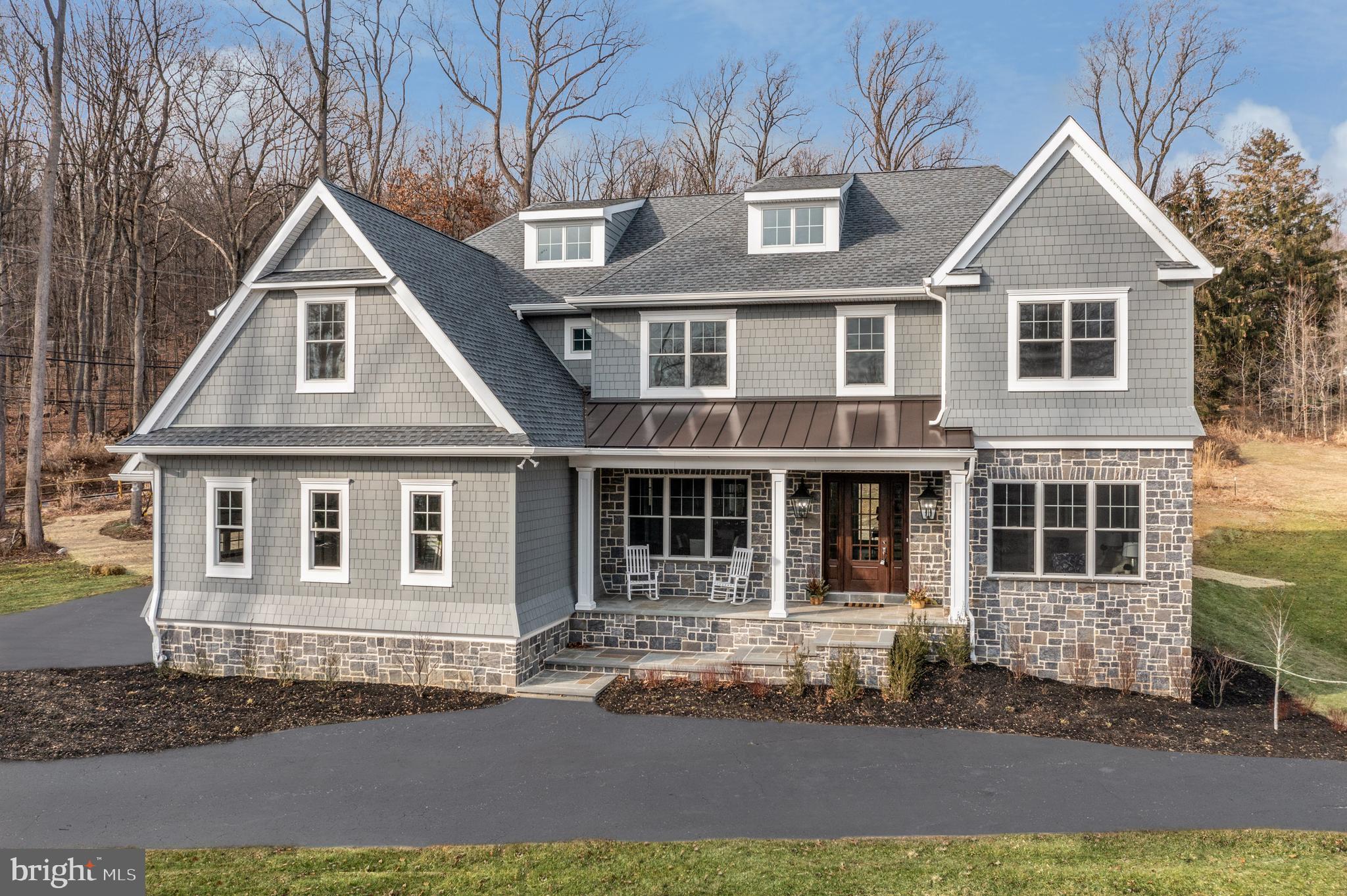 FABULOUS NEW CONSTRUCTION, JUST COMPLETED - MOVE IN READY! Brand New Quick Delivery Home in the Award winning Tredyffrin-Easttown School District, situated on almost 2 full acres. Top of the line finishes throughout entire home. Enter the large foyer from the flagstone front porch – The expansive main foyer opens to a spacious home with 10 foot ceilings. At the end of the Foyer there are sliders that lead out to the inviting Patio & backyard. The Foyer also has a formal Powder Room and a Coat Closet. To the right, there is a formal Living Room with crown molding and lots of natural light. To the left is the Dining Room with a Tray Ceiling and Crown Molding, complete with a Butler’s Pantry, which leads to the kitchen. The Kitchen is outfitted with high-end appliances, a pantry, and a large island for all of your entertaining needs. Tucked behind the kitchen is the rear stairs and access to the Three Car Garage, as well as a very large Mud Room with cubbies and a second Powder Room. The Breakfast Room features soaring ceilings and a custom center open slider out to the back yard completed with a beautiful Flagstone Patio. There is custom Wet Bar adjacent to the Family Room, in case you forgot your drink in the kitchen. The Family Room features a true masonry wood-burning fireplace, a Cathedral ceiling and lots of natural light. The first level is completed by a study with Glass Doors and a large bay window.
Upstairs you will find a spacious Master Suite, with two large walk-in closets, a large bathroom, complete with a two-sink vanity, large shower with a bench, and a free standing soaking tub. There are four other ample-sized bedrooms on this level. Bedrooms 3 and 4 have walk-in closets, and share a Jack and Jill Bathroom, outfitted with a double vanity and tub shower. Bedrooms 2 and 5 also share a Jack and Jill Bathroom, completed a double vanity and an over-sized shower. A generously sized Laundry Room with plenty of cabinets and a sink, completes this level.
The walk-up third floor is almost 1,000 sq ft of finished space. It has been drywalled, carpeted and pre plumbed – it can be an office, a playroom, or an additional bedroom. The basement (1256 sq ft) offers the option to be finished with or without a bath and provides lots of daylight with windows and direct access to the back yard.
This is the perfect opportunity for any buyer to own an estate of their dreams. Close to major highways and public transportation, as well as, the Valley Forge National Historical Park. The area is an eclectic mix of Chester County farm-land and Main Line convenience. The house is filled with an attention to detail and fine millwork throughout. Every decision has been thoughtfully considered, and there is room to make it your own!
Please Note: Property will be reassessed after settlement and taxes are TBD