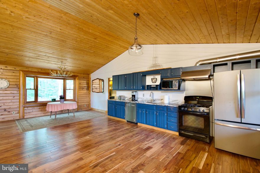 There is something special about Moyaone Reserve and there is something more special about this serene property which includes a primary house with 3bdrms/3.5 baths, and a guest house w/3 bdrms and 2 baths.  The 3248 sq ft PRIMARY HOUSE includes a 5 car garage with a lift and kitchenette area, covered parking for 2 cars and an extended driveway that can hold multiple cars with a rear entrance to the main road.  You'll be greeted by a long tree-lined extended driveway and end up at the primary house  which has an extended front porch.  This property is uniquely made with an open concept, volume ceilings, a stone fireplace, open modern kitchen and spacious living areas.  The primary suite is on the main level and offers tons of space, a sitting area, huge walk in closet, laundry area and a covered porch.   There is an additional room on the main level with volume ceilings that can have multiple uses.  This room has access to the carport area.   The wood flooring, large room sizes, finished lower level, a unique "grow" room/storage area, and several flexible room spaces allow for multiple uses of these areas to include office space, entertainment areas, relaxation room, sleeping area and more.   The 1200 sq. ft. GUEST HOUSE is an updated property and has some modern touches throughout including updated kitchen,  2 full baths and 3 bedrooms.  This unique layout allows for multiple uses, ie  residence, home office, gallery, rental unit and more.  This property has a central HVAC system.   As you make your way to this phenomenal property along the tree lined driveway, you’ll be drawn into the nature and serene vista views that Moyaone Reserve has to offer.   You won't want to miss out on the opportunity to own this unique property!  This is an estate sale.