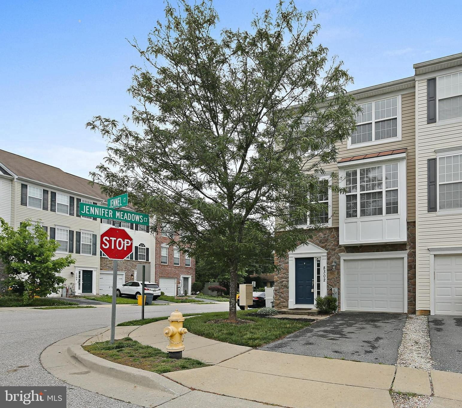 Back on the market as the buyer unfortunately lost their job. Your second chance is here! Welcome to 8302 Jennel Ct! This stunning 3 bedroom, 2 full bath, 2 half bath, End-Unit townhome, is ideally positioned in the highly sought-after Jennifer Meadows community. The home has been meticulously maintained, and boasts 2,180 sq ft of open-concept living space across three levels. The lower level features a spacious rec room, perfect for a playroom, office, or lounge, and opens via sliding doors to a fully fenced yard with patio. Great for outdoor gatherings or gardening. The main level includes a gourmet kitchen with granite countertops, center island, sleek black appliances, and a cozy sitting area with a gas fireplace. From here you can access the large back deck, great space for grilling and entertaining. The kitchen area flows seamlessly into the massive open concept living area filled with tons of natural light from the huge windows. Upstairs, the luxurious owner’s suite offers a tray ceiling, oversized walk-in closet, and an ensuite bath with double vanity sink, soaking tub, and separate shower. Two guest rooms, a second full bath, and convenient second-floor laundry with custom shelving complete the layout. Located minutes from Ft. Meade, NSA, and commuter routes, this home blends contemporary finishes with thoughtful functionality. Move‑in ready—don’t miss it!