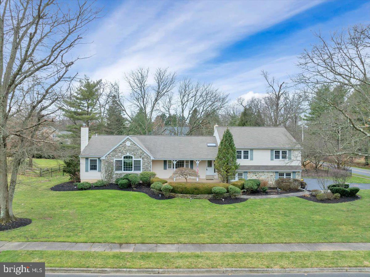 Fabulous expanded split level colonial with a main floor master suite right in the heart of Blue Bell. This 5 bedroom beauty boasts four levels of finished living space plus plenty of additional storage space. The main entry level includes an updated kitchen and breakfast room with a sliding door to the deck convenient for  grilling, the formal dining room and the formal living room, all with hardwood floors. The huge newer master suite on the main level includes double walk-in closets, a sitting room with gas fireplace, and a large bathroom with shower, jetted tub and double sinks surrounded by cabinets. The upper level includes 4 bedrooms, one of them includes a full bath with shower stall, plus there is an updated hall bath with tub/shower.  All upper bedrooms and stairs have hardwood under the carpet. The lower level which is above ground includes a large family room with a radiant heated floor under the tile, a lovely stone fireplace, a separate cozy sitting area, a glass enclosed spa room with hot  tub and radiant heated floor overlooking the beautiful backyard.  A French door from the family room leads to the rear patio and the beautifully landscaped, fully fenced yard.  Also on this level is the large laundry room with lots of cabinetry, plus the powder room and the entrance to the double car garage. Wait.....there is more. One more level down you will find another large room which could be a game room, play room or a fabulous gym, and there are two very large storage rooms, one with a workbench.  There is a sprinkler system in the yard to keep your grass and plants nice and green and the home includes a security system. If you are looking for a lot of room for the family to spread out, this is your new home. Blue Bell is surrounded by fabulous restaurants, shopping, parks and walking trails, with easy access to trains and highways in every direction, plus this home is in the highly rated Wissahickon School District. Schedule your showing today before it's gone.
