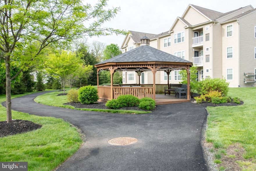 Nestled in the serene enclave of West Bristol, this exquisite 2-bedroom, 2-bathroom garden unit offers a harmonious blend of contemporary elegance and modern comfort. Built in 2019, this residence showcases meticulous craftsmanship and high-end finishes that create an inviting atmosphere, perfect for both relaxation and entertaining. As you step inside, you are greeted by an open-concept living space adorned with engineered wood flooring that flows seamlessly throughout. The cozy living area features a charming fireplace, providing a warm focal point for gatherings on chilly evenings. Large windows invite natural light to dance across the space, enhancing the inviting ambiance and offering a picturesque view of the surrounding area.  The gourmet kitchen is a culinary enthusiast's dream, equipped with top-of-the-line appliances and ample counter space for meal preparation. Whether hosting intimate dinners or casual brunches, this kitchen is designed to inspire creativity and connection. Adjacent to the kitchen, the dining area provides a perfect setting for enjoying meals with loved ones. Retreat to the spacious primary suite, a tranquil haven featuring an en-suite bathroom that exudes luxury. The second bedroom is equally inviting, offering versatility for guests or a home office. Both bathrooms are thoughtfully designed, showcasing modern fixtures and finishes that elevate everyday routines into spa-like experiences. Convenience is paramount in this residence, with in-unit laundry facilities ensuring that chores are a breeze. The property also includes one dedicated parking space, providing ease of access to your home and plenty of open parking spaces for guests. Outside, the well-maintained grounds of the community reflect a commitment to quality living, with services such as common area maintenance, snow removal, and trash collection included in the association fee.  The surrounding area offers a wealth of opportunities for leisure and recreation, allowing you to enjoy a lifestyle of comfort and convenience. This exceptional property is not just a home; it's a lifestyle choice that embodies luxury, tranquility, and modern living.  Experience the best of West Bristol and the close proximity to Bristol Boro with fun on the river, dinners at King George Inn and so much more, make this stunning residence your home.