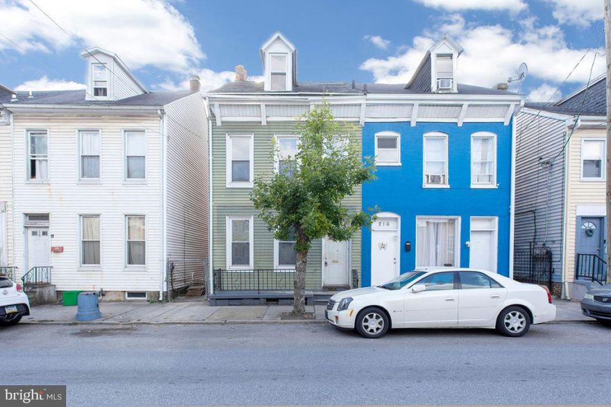 Semi-detached home with tons of possibilities.   3 bedrooms and 2 full baths.  2nd floor balcony access. Nice yard and detached 1 car garage.