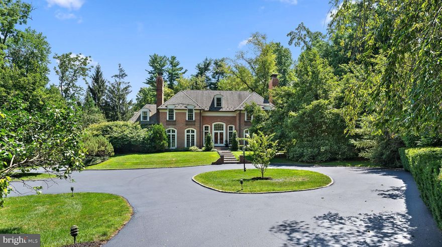 This stately brick Georgian Colonial is perfectly set on a quiet cul-de-sac overlooking the fields of historic Harriton House, in one of Lower Merion's most coveted Northside Bryn Mawr neighborhoods.  Truly a one of a kind property offering privacy and majestic grounds, a magnificent pool, an all brick exterior and a stunning interior. A hedge lined circular driveway invites you to be impressed by the private & beautifully manicured grounds. A flagstone walkway leads you to the dramatic entry with wide slate steps, and double door entry. Step into the romantic two story foyer complete with gleaming hardwoods, large windows streaming in sunlight, arched entryways and a dramatic curved staircase.  This estate's open floor plan and sunlit spaces make it an entertainer's dream.  The inviting living room with multiple french doors to welcome the outside in, is the perfect place to sit fireside and enjoy a book in front of the Marble surround gas fireplace.  The dining room can accommodate a large dinner party perfect for holiday celebrations, and features french doors, and a wood burning fireplace.  A chef's kitchen, designed by Joanne Hudson, overlooks the stunning grounds, this kitchen has been thoughtfully laid out and offers every amenity a serious cook desires, Thermador and Sub Zero appliances, two dishwashers, two ovens, dual sinks, an abundance of light custom cabinetry and a large island.  The sunlit breakfast room opens onto the wrap-around deck offering serene views and a delightful place to sit and sip your morning coffee as well as a lovely extension for casual indoor/outdoor entertaining. The kitchen is open to a cozy family room with fabulous hand carved mahogany built-ins and a magnificent sun room with 3 walls of windows offering unobstructed views of  the stunning yard and the idyllic Harriton House grounds beyond. The sunroom offers french doors opening to an outdoor patio.  A private home office with built-in cabinetry and shelving, and a stunning renovated powder room with designer tile accent wall are tucked in off of the foyer.  An additional powder room and mud room with ample closet space complete this level.  Climb the sweeping staircase and enter the double doors  to the Primary suite, and you are welcomed to a space reminiscent of a fine luxury hotel suite. The large bedroom has glorious vaulted ceilings, a gas fireplace with limestone mantel and sitting area. The bathroom is truly luxurious with separate vanity areas each with their own toilet room,  joined by an enormous frameless glass shower complete with rain shower head & handhelds, bench & mosaic tile.  A soaking tub and custom mahogany vanity with onyx top are just a few of the highlights of this spectacular bath! The oversized custom outfitted dressing room completes this amazing space. Down the Hall is an en suite bedroom with two custom outfitted closets and an updated designer tile bath with shower/tub combo. The third bedroom has a walk-in closet and its own sink and vanity and shares a recently renovated bath complete with linen tile, frameless glass shower door and a vanity with marble top, with the 4th bedroom. There is a third floor walk up attic that is perfect for finishing if additional space is needed, and is great for storage as is.  The walkout daylit lower level has a dressing room & full bath, perfect for the pool! A wet bar and two double glass doors opening to the bluestone patio & pool area make this a perfect place to entertain while using the pool and for caterers to set up for outdoor affairs. There is also plenty of storage, a wine closet and a cedar closet!  An oversized three car garage with additional storage space completes this home.   Overlooking  the Harriton house grounds where you occasionally catch a glimpse of their horse making it feel like the countryside, while living in the heart of Lower Merion School District. Close to shopping restaurants, schools, highways, & center city Philadelphia.