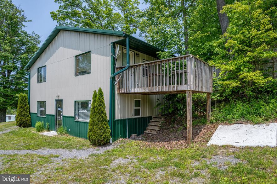 Exceptional Commercial Opportunity in the heart of scenic Bruceton Mills, WV! Unlock the potential of your business with this remarkable property that seamlessly blends functionality with versatility. Nestled just minutes from I-68, this 2,300 sqft commercial building is perfectly situated for optimal visibility and accessibility. Boasting a generous 34x64 footprint, this building offers ample space for a variety of business ventures. Whether you're looking to expand your current operations or start anew, the open layout invites endless possibilities. With three garage bays and an additional two-stall detached garage, this property is ideal for automotive services, storage solutions, or workshop spaces. Each bay is easily accessible, making operations smooth and efficient. Elevate your business with a private studio located on the upper level. This space features its own deck for relaxation or meetings outdoors, a kitchen for convenience, and a half bath, making it a fantastic addition for creative professionals or as a meeting space. With surveillance cameras strategically placed around the property, you can rest assured knowing your business space is safe and monitored. This commercial space isn't just a building; it's a canvas for your business aspirations. Imagine the potential of being part of a community that values entrepreneurship and innovation. Don’t miss out on this incredible opportunity to establish your business in a prime location. Contact us today to schedule your private tour and take the first step toward realizing your vision!