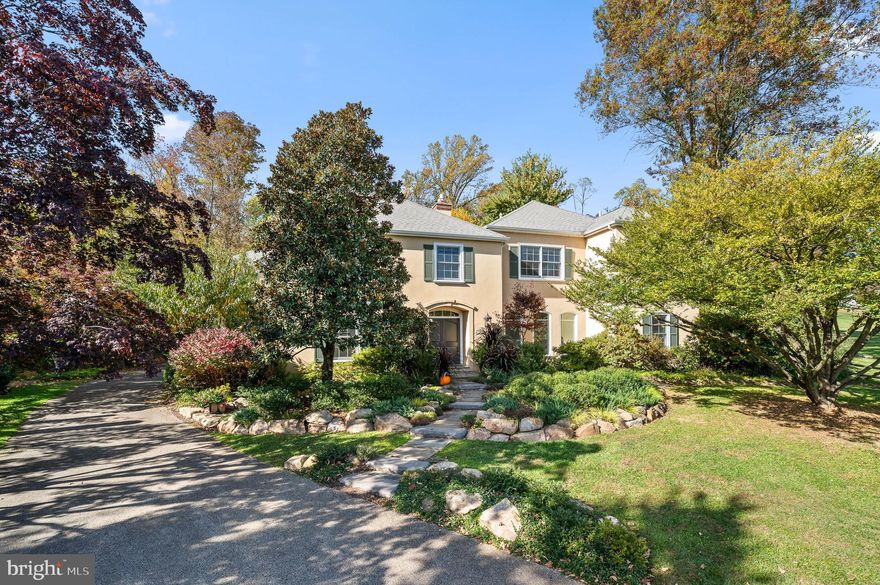 Welcome to this timeless masterpiece in the heart of Bryn Mawr, where French colonial charm meets modern elegance. This exquisite residence, nestled on a private cul-de-sac, offers a thoughtful floor plan, light-filled spaces and tranquil gardens in one of Lower Merion's most coveted locations, Northside Bryn Mawr. This stately home boasts five bedrooms including main floor ensuite bedroom with four full bathrooms. With french doors opening to the patio and gardens from every room in the rear, light filters into all the spaces and a generous floor plan provides great flow for entertaining and everyday living. The outdoor space is a true oasis, offering a serene retreat with blooming flowers, lush greenery, and thoughtfully designed garden pathways and sitting areas, including a fire pit. Whether enjoying a morning coffee or hosting a soirée, the gardens provide a picturesque backdrop for every occasion. As you approach the property a flagstone walkway surrounded by seasonal specimen plantings leads you to the double door entry. Step into the foyer and you are welcomed by gleaming hardwoods, large windows streaming in sunlight, and a beautiful staircase. The heart of this home is undoubtedly the expansive kitchen. A gourmet's delight, it features modern appliances seamlessly integrated into classic French design. From the large granite topped seated island to the bold Viking Range & professional hood this large kitchen provides an ideal space for culinary enthusiasts and is perfect for both intimate family meals and entertaining guests. The kitchen is open to a breakfast room and cozy sitting room with gas fireplace, a wall of windows and French doors offering views of the stunning flagstone patio with built-in bbq,  and charming garden walls with manicured grounds beyond. The adjacent dining room with built in corner cabinets and moldings can accommodate a large dinner party perfect for holiday celebrations. A spacious step down living room complete with gas fireplace offers a wonderful space for relaxing and entertaining guests.  A private home office with built-in cabinetry and shelving and custom wood paneling is tucked off of the living room for added privacy.  The Main floor Bedroom suite offers a wonderful space with an updated bathroom, including walk-in tiled shower and is perfect for guests, in-laws or a nanny! The powder room, oversized mud room/laundry room, back staircase and 2 car garage complete this level. The upper level of this home is expansive and offers flexibility catering to the homeowner's needs.  The primary suite is spacious with a vaulted ceiling and features two walk-in closets plus a sitting room with window seat, and a secret door to a hidden storage closet! The large primary bath offers vaulted ceilings and skylights, a soaking tub, frameless glass shower and a granite-topped double vanity. Down the hall find a second charming bedroom suite with a window seat and a neutral hall bath with a soaking tub and linen closet.  Two additional bedrooms share the fourth spacious full bath with shower and double vanity.  Bedroom 5 is oversized (was two bedrooms combined to create one, we have a quote for $8,500 to turn it back into two bedrooms) and could be an upper level playroom, studio or home office.  Bedroom five is also accessed by a back staircase. The finished lower level adds a layer of versatility to this already remarkable property. Whether it's a home theater, a game room, or a gym, this additional space offers endless possibilities. With its inviting interiors, stunning and enchanting gardens and walkways, and thoughtful design, this property invites you to experience the luxury of gracious living in a private and exclusive setting. Set in the heart of Award Winning Lower Merion School District, close to shopping, restaurants, schools, highways, Philadelphia & beyond. *Stucco inspected 2022, no issues.