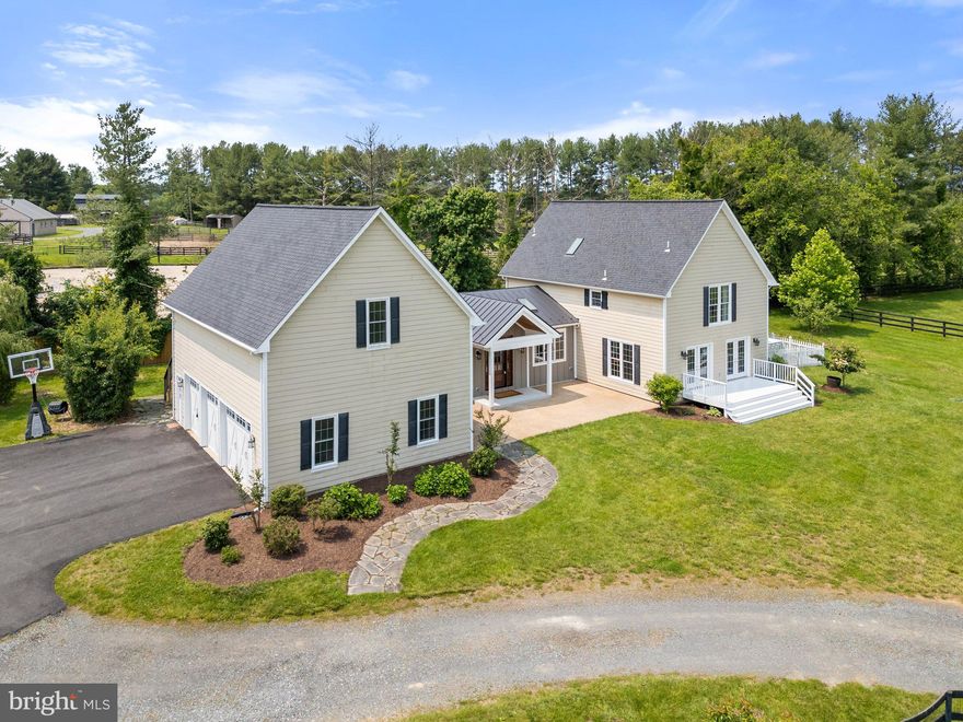 Welcome to a truly one-of-a-kind offering in the heart of Virginia’s horse country. This exceptional 4-bedroom, 3-bath home seamlessly blends rustic charm with modern elegance, all set on over 8.5 acres with sweeping views of the Blue Ridge Mountains. Originally a horse stable, the 3,300 square foot residence has been thoughtfully transformed into a warm, character-filled home while preserving unique architectural nods to its equestrian heritage—think vaulted ceilings, barn doors with soft-close hardware, and even a double Dutch stall door accessing the upper level.
Located just ten minutes from the historic village of Middleburg—long celebrated as a retreat for the rich and famous—this property combines privacy, style, and incredible potential. While it’s not currently an active horse property, it can easily return to one, with existing three-board fencing, a two-stall run-in shed, and a sand and bluestone arena ready to be restored. The property is in land use for lower property taxes, and the fast, reliable Starlink internet (equipment conveys) means you're perfectly connected whether working from home or streaming your favorite shows.
Inside, the home is a standout, with wood flooring throughout, a beautifully remodeled kitchen featuring a large island, and a stunning primary bath renovation. Vaulted ceilings elevate the kitchen, primary suite, family room, and second bedroom, creating a light-filled and spacious atmosphere. Adding even more versatility, a separate 700 square foot suite above the garage—with its own entrance—is currently used as a popular short-term rental or could serve as a private guest suite.
This home is not just beautiful—it’s built to last and made for easy living, with a 50-year architectural shingle roof added in 2017, a standing seam metal roof in 2019, upgraded 4-bedroom septic in 2020 (with room to expand), low-maintenance Hardiplank siding, and an insulated 3-car garage outfitted with storage racks. A pipestem driveway offers both privacy and convenience, with ample parking and proximity to Purcellville, Middleburg, major commuting routes, and Dulles International Airport.
Whether you’re looking for a quiet country retreat, a stylish entertainer’s home, or the foundation for your dream horse property, this special home offers the very best of Loudoun County living.
