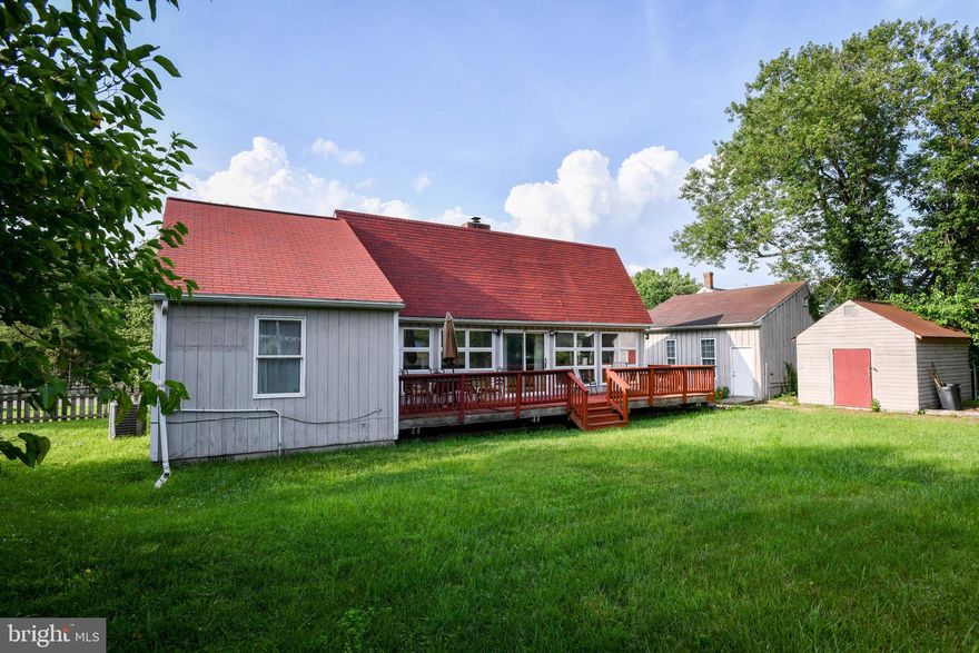 This bungalow style detached home sits on a large scenic corner lot with a fully fenced yard.  The detached 1-car garage has a half bath.  The garage offers a possible flex space or workshop area.  On the front of the home which has a southern exposure, there is a large deck for entertaining.  The open concept living area has tall ceilings with floor to ceiling windows from end to end. The windows bring in natural lighting and views from the yard.  Situated between the living and dining area is a wood burning stove providing an alternative heating source on those chilly days. There's hardwood flooring in the kitchen and dining areas with a ceramic tile inlay in the kitchen.  The nicely sized bedroom areas have laminate flooring and ample closet space  The secondary bedroom has a sliding door leading to the deck. This home is waiting for you to add your touches and some TLC. All of this and only one block walking distance from Metrobus stop! House is sold As-Is.