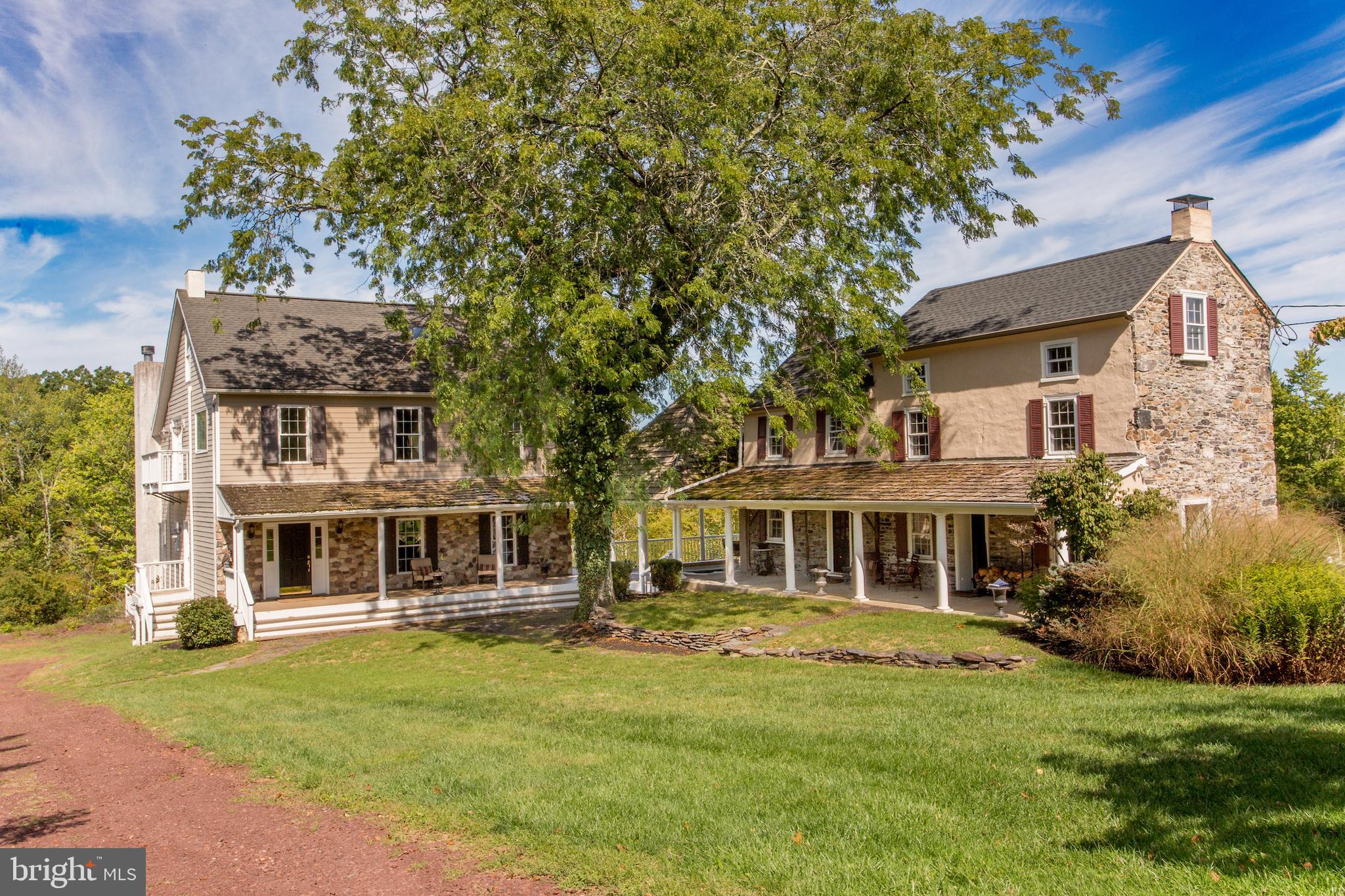 Seldom is there an opportunity to own an extraordinary property like this one. On one of the beautiful country roads in Solebury, Fox Hollow Farm has two special houses on 37 acres of lawns, meadows, and partially wooded areas. If a serene retreat, absolute privacy and a relaxed and gracious lifestyle is what you seek, this is a property that will capture your imagination. The gated entrance opens to a long driveway that takes you to two separate houses built 200 years apart. Honoring the authenticity of the original 1806 farmhouse, the main residence is a reproduction designed to be similar in exterior appearance but with the finest modern features for luxury living. The two homes share a large soaring height pavilion that has an expansive seating area and a sunken hot tub and connects the two porches. Enter into a home with a 2-story foyer that sets the tone for the inspired design and the materials used. Pillars, detailed millwork, random width pine floors, many windows for natural light, bedrooms with private balconies are a few. The formal dining room is perfect for intimate or large gatherings, and the efficient and beautiful eat-in kitchen has custom cabinetry, two dishwashers and a 2-level island w/seating. A full width living room is warmed by a woodburning fireplace and an Atrium door opens to a wraparound deck that connects to the pavilion. Completing the main level is a full bathroom. Upstairs is a wide hall from which you access the primary bedroom and bathroom suite overlooking the living room. A second bedroom has a hall bathroom next to it, A hidden staircase goes to the third floor attic, which is an enormous room to use as another bedroom or as flex space. Plenty of closets there! A huge walkout basement with 9’ ceilings and a door to a patio could be finished if you need more space. And then there is the original farmhouse dating back to 1806! Imagine if walls could speak! A grand house built by a wealthy landowner, it is an amazing three level home with authentic period details and modern conveniences. With almost 2000sf of space, the main level has the “traditional” large dining room with a woodburning fireplace and the living room is filled with period charm. An in-the-wall brick fireplace, pumpkin pine floors, deep sill windows, Dutch doors, a powder room and an efficient kitchen is the main level. The second floor has two bedrooms, an office or sitting room, two bathrooms, one ensuite, and a back staircase to the first floor. The house is currently rented but offers many possibilities for its use. The outdoors is filled with ponds, garden beds, a bubbling creek under a bridge, statues, bluestone walkways, an original springhouse, dry stack stone walls, and so much more. Two garages have space for vehicles, equipment and storage. Some exterior work on roofs and painting of the wood decking is needed and estimates for the work will be available. Bring your vision and creativity, your love of old and newer homes, beautiful surroundings, and a serene place to retreat to and renew. It's quite a property to call home. A spectacular farm in an excellent location close to New Hope, Doylestown, and Newtown and their amenities and commuting routes. The seller will not entertain any offer that is subject to a subdivision approval. One parcel with 37.9 acres and two small adjoining parcels with1.09 acres combined