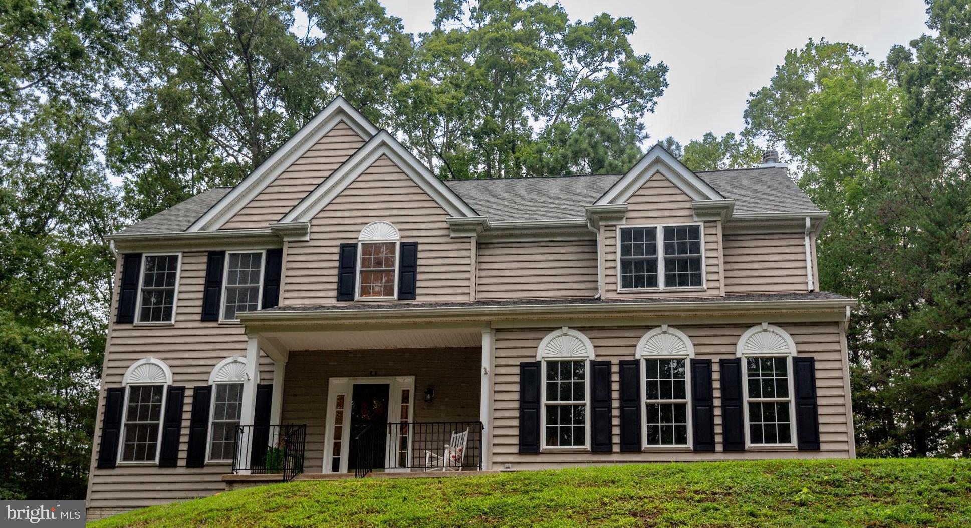 Nestled in the serene community of Cove Point Woods, this charming Colonial home offers a perfect blend of comfort and modern living. With 4 spacious bedrooms and 2.5 bathrooms, the open floor plan invites you to enjoy gatherings in the family room, seamlessly connected to the dining area. The heart of the home features upgraded countertops and stainless steel appliances, including a double oven, ideal for culinary enthusiasts. Retreat to the primary suite, complete with a luxurious soaking tub and walk-in closet, providing a private oasis. The warmth of wood floors and a cozy fireplace with glass doors enhances the inviting atmosphere throughout. The full basement, with interior access and a walkout level, offers endless possibilities for customization. Set on a generous 2.48-acre lot, the property is partly wooded, ensuring privacy and a tranquil setting. Enjoy outdoor living on the deck or porch, perfect for morning coffee or evening relaxation. The attached side-entry garage and ample driveway parking add convenience to your daily routine. Cove Point Woods is not just a neighborhood; it's a community. Residents benefit from nearby parks, walking trails, and excellent public services. Local schools are known for their commitment to education, making this area a desirable place to call home. Experience the perfect blend of nature and community in this delightful residence, where every detail is designed for comfort and enjoyment.