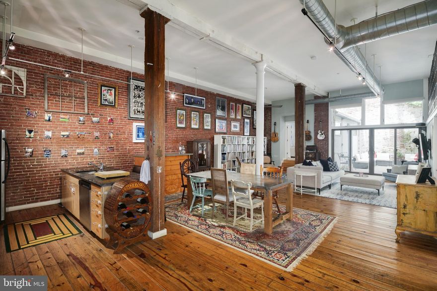 This stunning 2 bedroom, 2 bathroom, condo with MASSIVE private outdoor oasis and covered garage parking in the heart of Northern Liberties is truly one of a kind! The NY loft style condo is located on the first floor of a converted warehouse with original plank hardwood flooring, exposed brick, exposed beams, and exposed columns. Enter into the building to find a beautiful foyer/mailroom before walking through your front door and into the open concept layout of unit 1B with nearly 1700 sq ft of living/entertaining space and 12 ft +/- ceilings. This light filled condo has been meticulously maintained and has had several updates including both full bathrooms being fully renovated within the last 2 years, added storage above primary bathroom, motorized blinds, smart ceiling fans, Nest thermostat, Yale smart lock, and reclaimed industrial windows above primary bedroom. The kitchen boasts granite countertops, stainless steel appliances, an island with built-in breakfast bar, and plenty of cabinet space. Continue through to find the primary bedroom with NY style black and white en-suite Jack and Jill bathroom with double sink vanity, shower stall, exposed brick, and full sized stacked washer/dryer. The 2nd bedroom also has a full NY style black and white en-suite bathroom with tub/shower combo. The piece de resistance is your PRIVATE outdoor retreat complete with original exposed steel beams, custom built in planter with manicured landscaping and the perfect relaxing space in the heart of Northern Liberties to unwind and entertain; an incredibly rare find in Philly. Steps from 2nd Street and the heart of Northern Liberties with some of the best restaurants/bars in the city including Standard Tap, Bourbon & Branch, Heritage, Cantina Dos Segundos, Jerry's Bar, Honey's Sit'n Eat, Rustica Pizza, North Bowl, the Piazza and SO MUCH MORE!