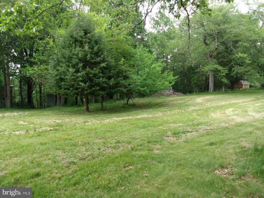 Beautiful camping lot, just a couple miles from the WV state maintained Potomac River Boat Ramp in Paw Paw WV.  Has a open grass clearing, 32 x 16 camper pavilion with deck ready for you to slip your own camper into place. Also set up for multiple campers.  Electric on site. Well on property (condition unknown), Unrestricted land and No HOA!!!  With Green Ridge State Forest, C&O Canal Trail, Paw Paw Tunnel and Sidling Hill WMA all very close, this is a sportsman's dream come true. Take a look at this gem today.