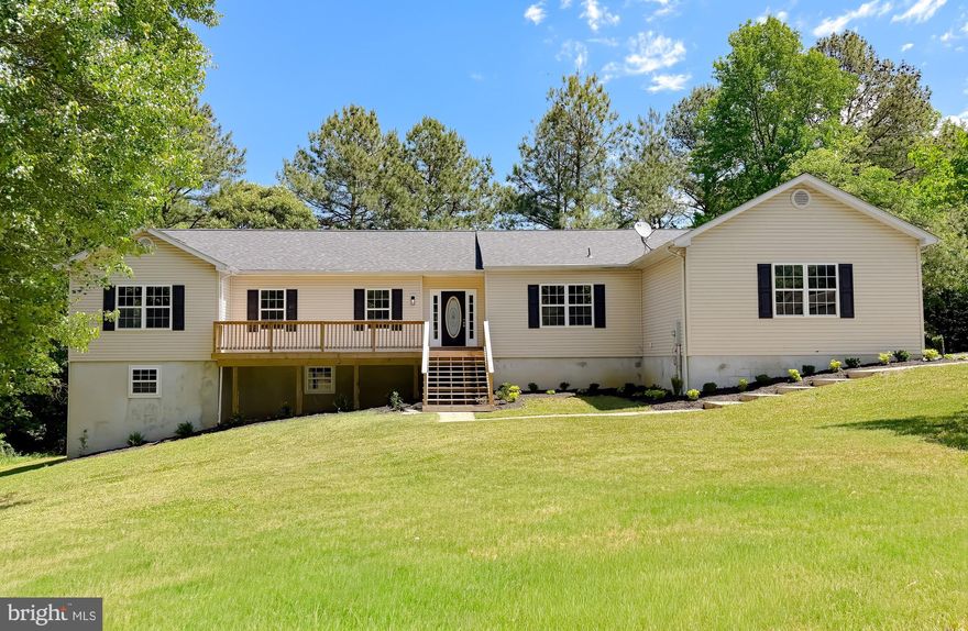 OPEN HOUSE - Saturday May 16th from 11-1!  Welcome to this beautifully renovated home on over 3 Acres!  This home features 4 bedrooms and 2.5 bathrooms.  As you enter, you will love the open concept feel with the kitchen open to 2 different living rooms.  The kitchen features new white cabinets, an island, stainless steel appliances, and quartz countertops.   Off of the kitchen, there is a spacious living room with a fireplace and a second living room that can be used as an office, dining room, flex room, and more!  Enjoy the beautiful outdoors on the brand new deck off of the kitchen.  As you head down the hall, you will find a large primary bedroom and a large primary bathroom featuring a double vanity, soaking tub, and tiled shower.  This floor also features 3 additional spacious bedrooms and a bathroom with a tiled bathtub.  There is also a laundry room and half bathroom on this floor.  As you head downstairs to the unfinished basement, the possibilities are endless in this big open space.  The walk out basement opens up to a spacious backyard filled with trees and privacy.  Enjoy your coffee on the beautiful front porch.  This home features a 2 car garage, an oversized shed, and 9 foot ceilings.  This home is close to many restaurants, shopping, and is a short commute to Joint Base Andrews, NAS Pax River, Annapolis, and Washington D.C.