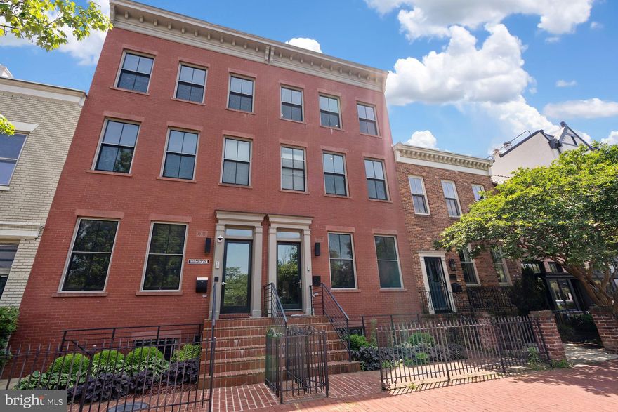 Gorgeous 5BR/5.5BA federal-style brick townhome with stunning modern renovations and incredible outdoor space in a Capitol Hill location that can’t be beat. Wide-plank ebony flooring, massive windows with serene tree views, and a stone fireplace beautifully frame the home’s impressive open layout. Grand architectural features fill the home with high ceilings, extensive millwork, built ins, tray ceilings, and exquisite material selection. The home’s flexible layout offers many living and entertaining configurations with three living areas and outdoor space to enjoy on every level. The sleek chef’s kitchen wows with custom cabinetry, pro stainless steel appliances, and quartz waterfall countertops opening to an elegant dining room as well as a secluded deck and brick patio. 

Hardwood and iron stairs lead to the graceful primary suite with floor-to-ceiling windows, a private balcony, custom walk-in closet, and a luxuriously tiled en suite bath with a soaking tub, dual vanity, and a frameless glass waterfall shower. The remaining bed and bath rooms mirror the primary suite’s sophistication. The finished lower level offers amazing bonus space to suit a variety of needs with plush carpeting, kitchenette, bedroom, bathroom, and storage. The rooftop deck will easily become your favorite spot to relax and entertain with peaceful treetop and bell tower views. Parking for two and an elevator along with zoning for residential, commercial, or mixed use complete this must-see contemporary masterpiece. 

The home’s location is a dream with the lush greenery of Stanton Park right next door with only a few blocks to the Capitol and Senate and House office buildings.  Easy errands, great coffee shops, and restaurants surround the home. The neighboring H Street Corridor and Eastern Market add even more to see and do. Metrobus is on the next block and Union Station a few blocks away for easy downtown commuting.