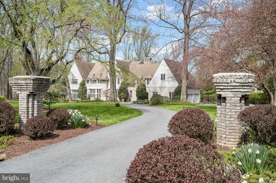 Offers Due Tues. 4/16, 5:00 PM. Residing in a quiet and private cul-de-sac, 8808 Potomac Station Lane presents a true English Country Tudor home. A masterful collaboration between renowned builder Jeffrey Snyder and the original owner, this sprawling landscaped 2-acre estate boasts 5 Bedrooms, 6 Baths, 2 Half Baths, as well as stunning design features such as handsome custom millwork, double crown molding, gleaming hardwood floors and recessed lighting throughout 3 elegantly curated levels and 9,542 square feet. 
The light-filled, tile floored Entry Foyer, showcasing 2 closets and a Tudor arched entry, beckons residents and guests alike to the Receiving Foyer, featuring a chandelier, ceiling medallion and a substantial reclaimed newel post, a remarkable welcome for any guest! The captivating two-story oak paneled Library will delight avid readers, offering a wide wood paneled Tudor archway, paneled walls, stunning built-ins and a spiral staircase leading to circular built-ins overlooking the grandeur below. Following the Library, the Living Room awaits, showcasing a wood-burning fireplace with a carved wood mantle and marble surround for serene and inviting gatherings. The elegant Rear Gallery, complete with stained glass windows, perfect for art collectors, effortlessly leads residents to the banquet sized Dining Room. Boasting timeless built-ins with trompe l’oeil cabinet doors, ceiling moldings, a ceiling medallion and 2 crystal chandeliers, the Dining Room encapsulates the idyllic, elevated dining experience. The Gourmet, Eat-in Kitchen, complete with updated appliances, granite counters, Tudor cabinetry and a pantry closet will surely exceed any at-home chef’s expectations. The sunny Breakfast Area, complete with a charming French Door and Rear Deck access beckons enjoyment of Sunday coffee with loved ones in this comforting setting! The sumptuous Family Room showcases an impressive stone fireplace, coffered ceilings, leaded glass doors leading to the Rear Gallery and Rear Patio access. The Main Level is complete with 2 Powder Rooms. 
Ascending to the Upper Level, the Primary Bedroom presents 2 spacious Walk-In Closets, an ensuite French inspired Bath and a Sitting Area overlooking the verdant Rear Yard and in-ground pool. The spa-like ensuite Primary Bath boasts wood vanities, dual sinks, an oversized jetted tub and tiled stall shower with bench seating; decompress and unwind in this relaxing oasis! 3 additional Bedrooms offer ensuite Baths with tile flooring, vanities and tub showers with tile surround. 2 of these Bedrooms offer Walk-In Closets as well. Down the Upper Hall, the In-Law Suite presents the ultimate guest experience, offering a private Living Room, Dining Area, and full Kitchen with updated appliances, featuring separate access to the garage and porte-cochere. Its Guest Bedroom Suite showcases a large closet and ensuite Bath complete with a linen closet, vanity and stall shower with tiled surround. 
Descending to the Lower Level, the Recreation Room is fully equipped for entertainment with laminate parquet flooring, recessed lights and a brick wood burning fireplace with wood storage and raised hearth. The Bar Area presents a circular walk-behind bar with tray ceilings, a Tiffany style chandelier, and French door to the Rear Lower Terrace. The Second Recreation Room offers Rear Lower Terrace access as well; from an at-home gym to a modern office space, residents can transform this room to align with their passion! The Lower Level is complete with a Rear Hallway, Full Bath, Fully-Finished Work Room, Utility Room and Wine Cellar or Bonus Room – the options are limitless! 
Complete with an asphalt circular drive, a porte-cochere, an in-ground heated pool and stunning seasonally inspired landscaping, 8808 Potomac Station Lane boasts countless amenities in addition to its historic architectural charm, offering residents a once-in-a-lifetime opportunity to create new memories in this breathtaking home.
