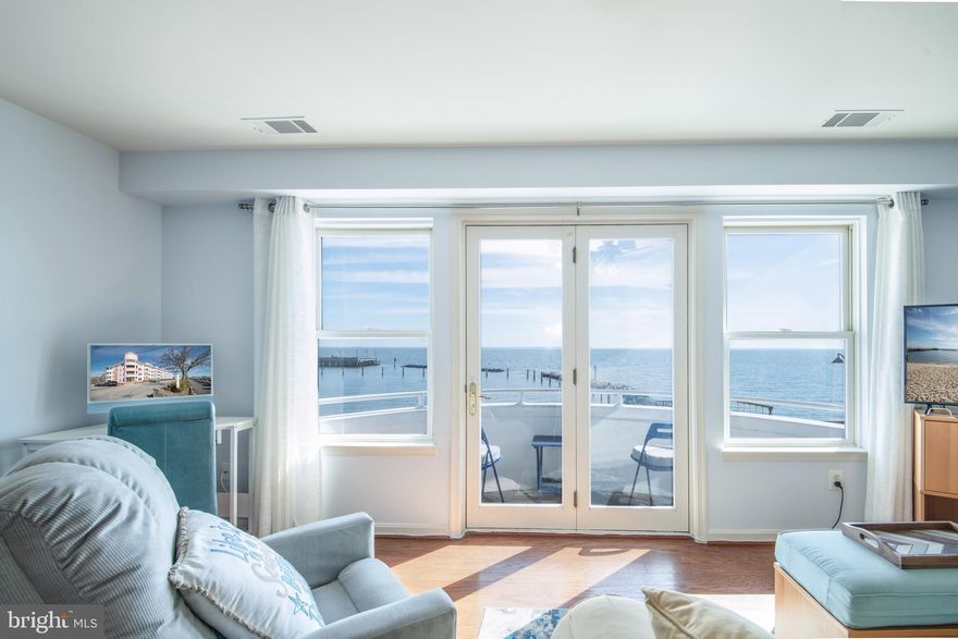 *Multiple offers have been received.  Offer deadline has been set for Monday 3/25 at noon.* Introducing a remarkable opportunity to live your vacation lifestyle every day of the year! This beautifully updated two-bedroom, one-bath condominium is an amazing retreat with expansive 180-degree Chesapeake Bay views. Step inside to a living space where every detail has been thoughtfully designed for your comfort and style. The kitchen features gleaming stainless-steel appliances/granite countertops and is perfect for both casual meals and dinner parties with friends. In addition, the freshly painted interior and newly installed hardwood floors make this unit move-in ready!  As a resident, you'll enjoy free access to a pristine beachfront where you can relax and reconnect with nature. Your new home extends beyond its walls to include a half-mile boardwalk, perfect for leisurely strolls and a vast fishing pier for the angler enthusiast. Celebrate life's moments with spectacular sunrises, Fourth of July fireworks, summer dragon boat races, the festive Christmas parade and tree lighting—all from the privacy of your own home. 9000 Bay View is just a stone's throw away from vibrant community offerings, including the soon-to-open state-of-the-art Twin Beaches public library, boat slips, kayak storage, and fabulous dining and entertainment options. Enjoy the convenience of a local farmers' market, "First Friday" celebrations, community campfires, movies on the beach, and cultural activities that make North Beach a truly unique place to call home. Don't miss this chance to turn your dream of waterfront living into reality. Set up your private tour today!