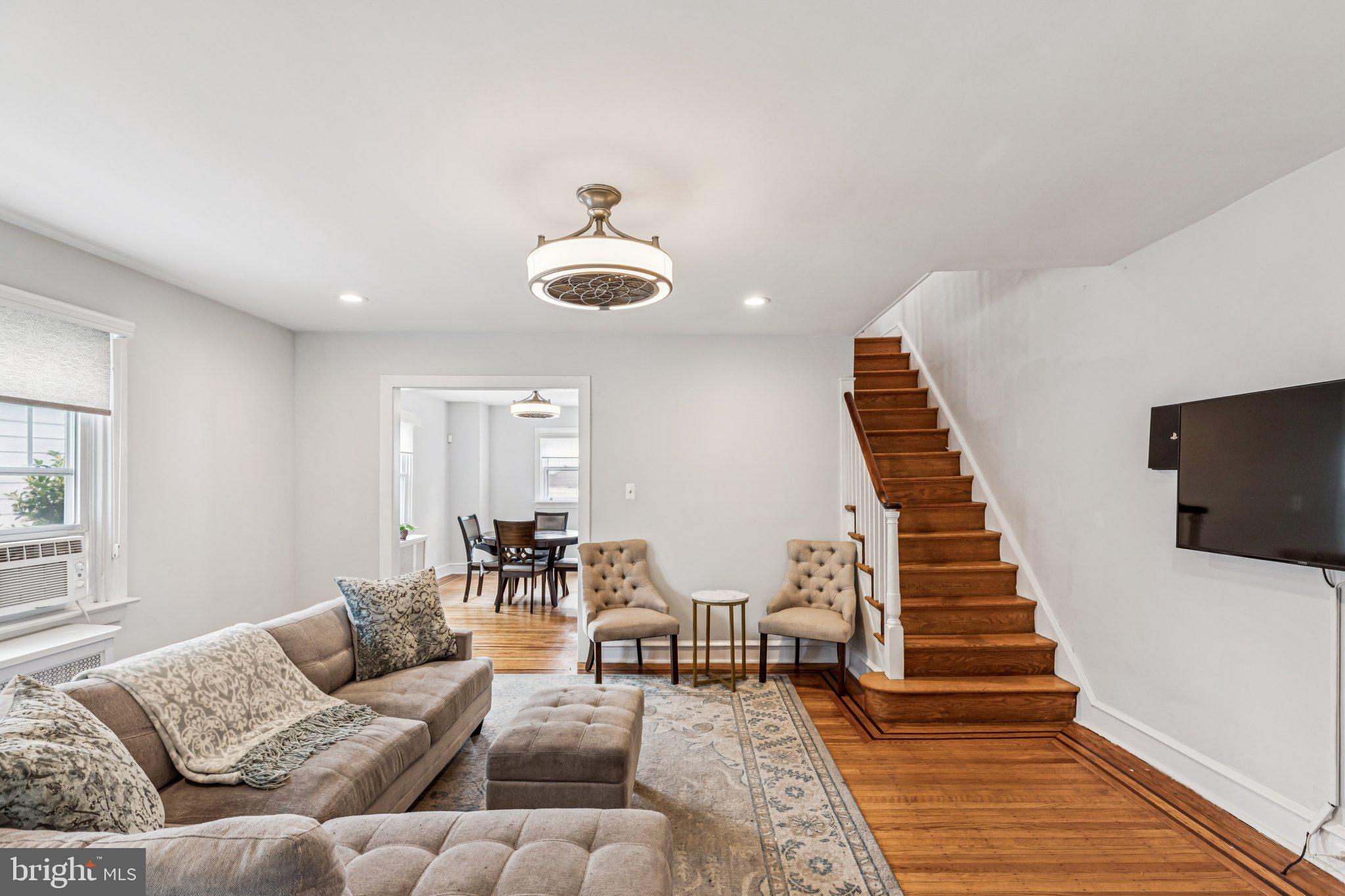 Welcome to 92 W Plumstead Ave, a charming 4-bedroom, 1-bath home tucked away in a quiet, friendly Lansdowne neighborhood. Perfectly situated near Philadelphia and the airport, this home offers both peaceful living and easy access to the city. Step inside to a welcoming enclosed porch with tiled floors, a perfect spot for morning coffee or relaxing evenings. Beyond the double doors, you’ll find a spacious living room highlighted by a beautiful decorative fireplace and hardwood floors that continue into the dining room. The kitchen features granite countertops, tiled floors, and access to the back deck overlooking the generously sized backyard. Upstairs, the second floor offers three comfortable bedrooms and a full bathroom that was thoughtfully renovated in 2022 with a new tub, updated plumbing, a handheld showerhead, fresh wall surround, and ceiling panel. A finished attic provides flexibility as a 4th bedroom, office, or playroom. The basement is well-maintained with plenty of storage and features a new walkout door (2024) for added convenience. Additional updates include a new water heater (2022), foyer window shutters (2019), and laundry appliances with a washer (2023), fridge, and dryer all included. Outside, you’ll enjoy off-street parking for two cars with a detached garage and driveway. This lovingly maintained home combines comfort, character, and modern updates all in a peaceful neighborhood that makes you feel right at home.