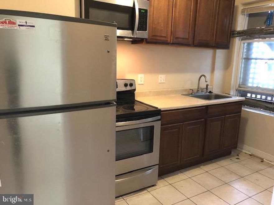 EXCELLENT VALUE FOR THIS PORCH FRONT ROWHOME IN HOT EDMONDSON VILLAGE!  Features include a spacious living room, separate dining room, galley kitchen with ss appliances, upper level with 3 bedrooms & 1 full bath, full basement that can be finished to add more living space, and a rear fenced yard.  Tons of renovations going on in the area!  Sold As-Is!