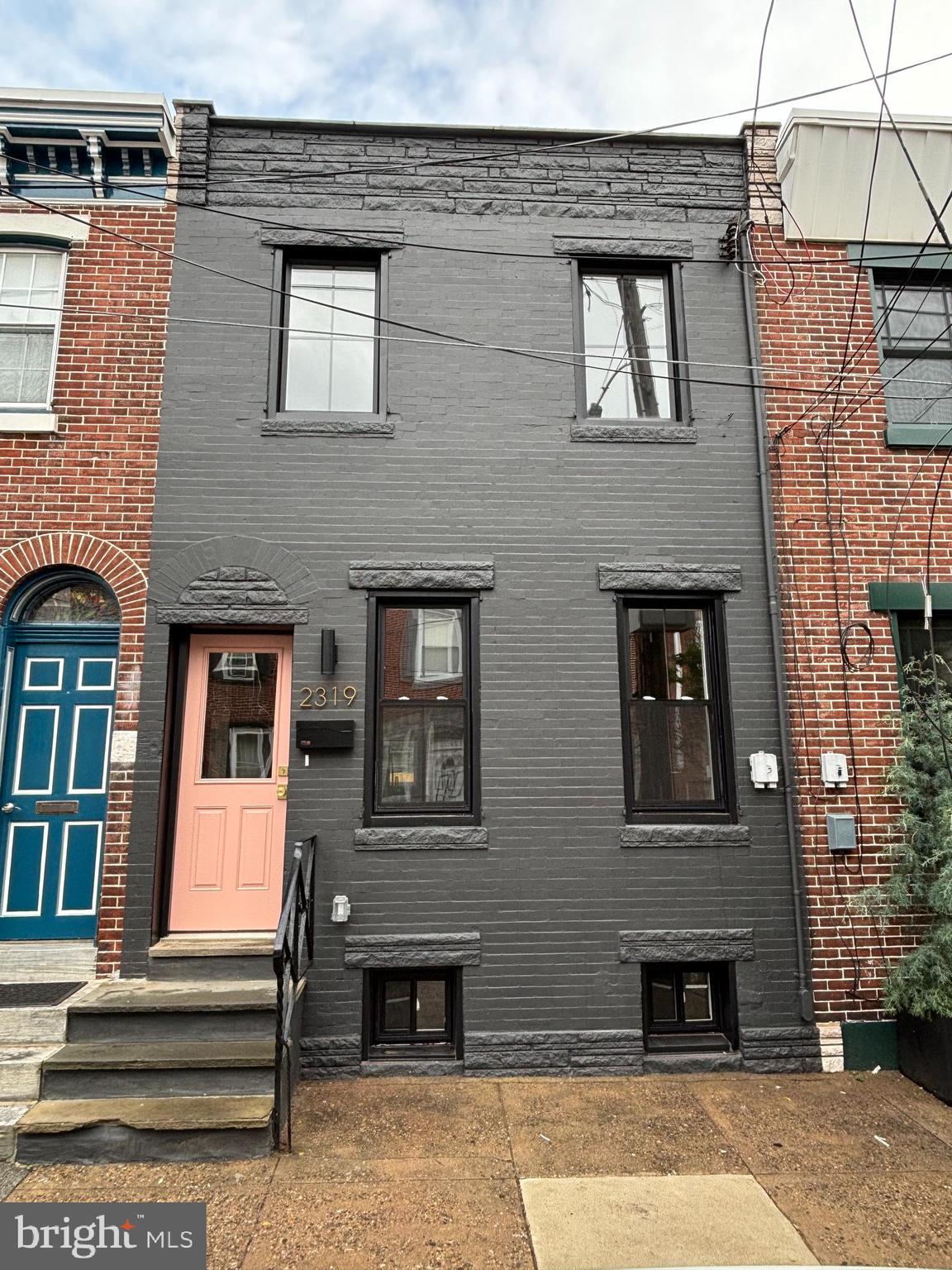 Finally, the Fishtown home you have been waiting for! 2319 Tulip Street is a 2-story home located in the heart of Fishtown on one of the best blocks in the neighborhood. This 15-foot-wide home has been renovated from top to bottom and comes with an approved 10-year rehab tax abatement!! The home features 2 large bedrooms, 1.5 bathrooms, a dedicated laundry center outside the primary bedroom, massive rear yard and so much more! Enter the home to be greeted by a completely open layout, with herringbone oak hardwood floors flowing from front to back. The living room is adorned with exposed brick and a stylish bump out with Della Bianco large format tile. Continue to the spacious dining area with custom chair rail molding and a chic pendant light. Just off the dining room is a convenient half bath, drenched in a sophisticated floral wallpaper and gorgeous wood vanity. The open-layout kitchen features cream shaker style cabinets with crown molding, undercabinet lighting, a farmhouse sink, brushed gold hardware, quartz countertops and backsplash, and Frigidaire stainless steel appliances. An inviting glass door allows the natural light to just pour in, and leads to the private and spacious rear yard, with brand new concrete and wood fence. Head downstairs to the clean but unfinished basement, perfect for storage. No expenses were spared at 2319 Tulip, with custom white railings with wood tops that lead to the second floor. The home showcases the same stunning herringbone hardwood floors throughout the second floor as well. The secondary bedroom has great closet space and features multiple large windows. Between the bedrooms is an incredible bathroom, showcasing a full tub with wall-to-wall tile, 60” wood double vanity, and gold hardware / mirrors. Just outside the primary bedroom is a conveniently located GE Laundry Center. The sun-soaked primary bedroom features more exposed brick, lime washed textured paint, and a pair of elegant sconces. A stylish barn door leads to a custom built dual sided walk-in closet with tons of space, with a private entrance into the bathroom. All permits pulled for new mechanicals with central air and heat, PEX plumbing manifold, a new electrical panel with new electrical service line, and all new windows. Located on an amazing block, close to both Frankford and Girard Avenues, this home is just a short walk from all the shops, bars, and restaurants that Fishtown has to offer. Rarely does a home with this design aesthetic in such a desirable location come on the market. Book your showing today before it is too late! Owner is a licensed real estate salesperson in the state of PA.