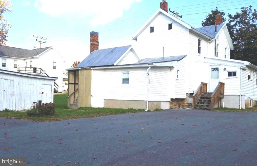 WOW! So many possibilities, bring your ideas and make this home your own! This home has the potential to be a multi-family unit or a single family home.  The home has 2 kitchens, 2 laundry rooms and separate entrances.  Large detached building and beautiful level backyard.  Driveway provides off street parking spaces.  Attention investors! Great opportunity to live in one side and rent the other. Earn sweat equity with a little TLC bring this home back to life! Great location.