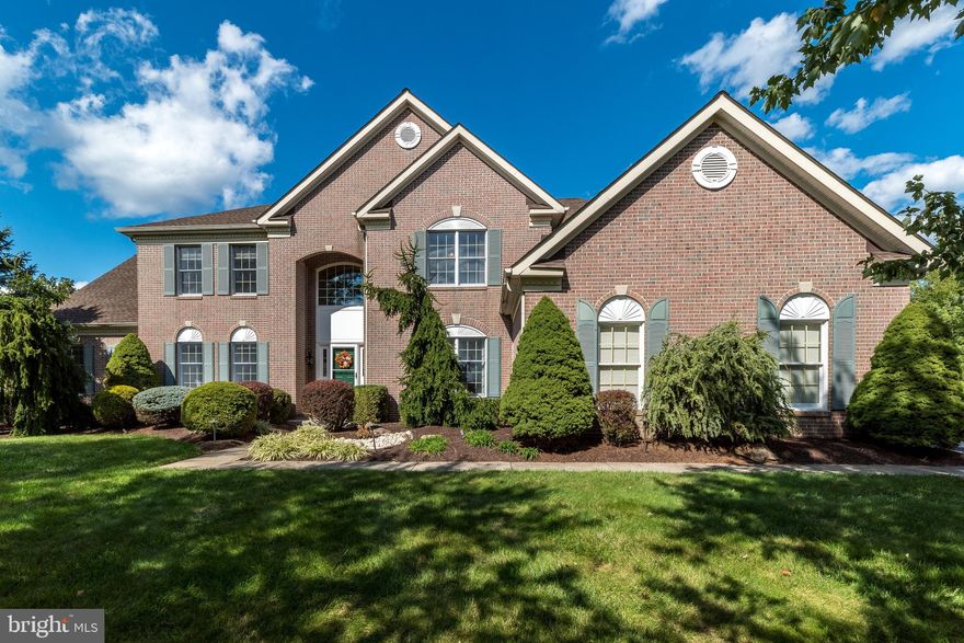 This stately brick front, center hall Colonial is located on a 0.68 acre lot in one of Buckingham Township's premier neighborhoods. The elegantly appointed Sterling model home by Toll Brothers features a bright and spacious 5,121 sq.ft. floorplan. Natural light drenches the 2-story entry foyer accented by a curved oak staircase and gleaming hardwood floors. Double doors off the entrance open to reveal quieter space for home office or studies, complete with built-in cabinets and shelving. High ceilings and custom millwork create great spaces to entertain in both the Living Room and Dining Room. An expansive Conservatory provides a great space to enjoy the latest mystery novel, and a door leading to the screened-in porch. Here, walls of windows frame the newly landscaped backyard oasis with in-ground heated saltwater pool with spa, and a large paver patio calling for barbecues in the tree-lined yard. Back inside, the host will appreciate easy access from any of these spaces, including the Dining Room, into the spacious Kitchen. 42” cabinetry along with a full-size pantry provide plenty of storage, and a tiled backsplash accents the granite counters. The center island features an overhang for seating and is open to the Breakfast Room, which flows effortlessly into the 2-story Family Room featuring a floor-to-ceiling brick gas fireplace. The Laundry Room is conveniently located on the main level and provides a handy utility sink along with inside access to the side-turned garage with 3 new garage doors. A powder room completes this level. Ascend to the second level via the front or back staircase, where the expansive primary bedroom suite is complete with coffered ceiling, a den/sitting room, and two walk-in closets. The master bathroom features a vaulted ceiling with skylight, double vanities, a soaking tub, separate stall shower, and private water closet. The Prince/Princess Suite enjoys a private bathroom, and two more bedrooms (one with double closets and the other with a private entrance to the bathroom) share a full bathroom located in the hallway. Even more living/entertaining space may be found on the Lower Level with finished spaces including a Recreational Area with wet bar and under-counter refrigerator. There is also a Media Room and a bonus room or 5th bedroom with closet and full bathroom. Some of the more recent updates to this well-maintained home include fresh paint throughout and new carpeting in most rooms, a new roof, all new mechanics including 3 HVACs, new sump pump, and new hot water heater. The Oaks of Buckingham enjoys walking paths to nearby parks, and is a few minutes’ drive into Historic Doylestown with shopping, dining, local attractions and cultural events. Easy access to major commuter routes. All this in the award-winning Central Bucks School District. Make your appointment today!