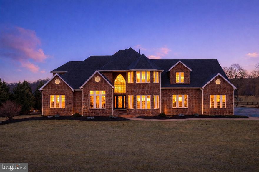 Bring your horses!!  Nestled on a picturesque 7+ acre lot, this luxurious estate is within 5 minutes from downtown Winchester, offering the perfect blend of privacy, space, and convenience. This property includes a 2-stall barn with electricity and multiple paddocks!  Opportunities like this are rare—enjoy the tranquility of country living while remaining in one of the area’s most desirable and accessible locations.
Inside, hardwood floors flow throughout the home, beginning with a grand entrance and impressive foyer that sets the tone. The main level features a formal dining room, a private office with elegant French doors, and a spacious family room centered around a cozy gas fireplace. The kitchen is designed for both function and gathering, complete with granite countertops, a large peninsula, and a charming breakfast nook overlooking the property.
The first-floor primary suite provides a true retreat, featuring French doors leading outside, a wet bar, two large walk-in closets, and a luxurious en-suite bath with dual vanities, a soaking tub, and a walk-in shower.
Upstairs offers exceptional space and flexibility with 3 additional bedrooms and multiple flex spaces and storage options. One bedroom features a walk-in closet and full bath, making it the perfect guest suite. The other bedrooms all offer ample closet space and share a jack and jill bathroom. A light and bright flex room is highlighted by skylights. Another smaller room can be used for a second office or storage closet. A large bonus room over the garage offers an abundance of finished space. 
Enjoy beautiful sunsets and pasture views, with a barn complete with electricity, multiple fenced enclosures and plenty of yard space for entertaining friends and family. 
With expansive acreage, privacy, and a highly sought-after location so close to town, this property is a rare opportunity to own a beautiful estate without sacrificing convenience to amenities.