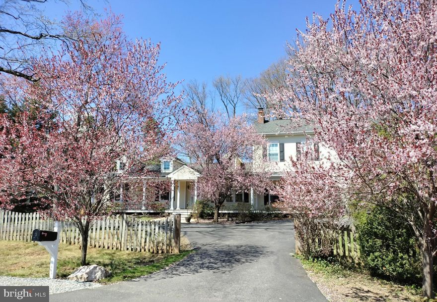 Nestled on a private, beautifully landscaped .78-acre lot at the end of a cul-de-sac with parkland at your doorstep & access to Gerry Connolly cross-county 40.5 mile biking/walking trail, this exceptional property blends timeless character with thoughtful modern updates in an unbeatable close-in location. The home has been meticulously expanded, updated, and improved while maintaining its warmth and charm.

A stunning 60-foot columned front porch crafted with Ipe wood and accented by dual ceiling fans welcomes you and provides the perfect place to relax and take in the peaceful, tree-lined setting. The expansive grounds feature custom stone patios and walkways, a striking stone accent wall, lush gardens, and a wide variety of mature flowering trees—creating a truly private and rarely found outdoor oasis. A circular six-car driveway, two storage sheds, and a fenced backyard complete with an in-ground pool and new solar cover make this property ideal for both everyday living and entertaining.

Inside, a gracious marble-floored foyer welcomes you and leads to a light-filled living room with vaulted ceilings, a dormer window, a woodstove, and atrium doors that frame stunning views of the backyard—creating a warm yet airy gathering space. The formal dining room, located just off the kitchen, offers an elegant setting and features a Hearthstone soapstone wood stove. The inviting family room—also adjacent to the expansive chef’s kitchen—is wired for surround sound and provides a comfortable and spacious area for everyday living. A mudroom conveniently separates the family room from the garage.

The expansive chef’s kitchen is thoughtfully designed with 42” custom cherry cabinetry, including a pantry with pull-out shelving, Brazilian granite countertops, a center island with breakfast bar, and premium stainless steel appliances including a Viking gas cooktop & vent hood, Bosch dishwasher, KitchenAid counter-depth refrigerator, and KitchenAid convection double oven. Abundant recessed and under-cabinet lighting complete this well-appointed space.

The main level also features three bedrooms, including one of two primary suites with a skylight, built-in cabinets and bookshelves, en-suite bath, and sliding glass doors providing direct access to the patio and pool. Upstairs, the expansive owner’s retreat offers a luxurious escape with vaulted ceilings, dual walk-in closets, a generous sitting area, and a spa-like bath with a soaking tub, separate shower, and dual vanities. An additional large bedroom with soaring ceilings and ample closet space, a full bath, and an oversized bonus room/loft—perfect for a gym, studio, or media space—complete the upper level.

Additional highlights include zoned gas heating and cooling with a new Carrier system (2025), two gas water heaters (one new in 2020), updated thermopane windows, recessed lighting throughout, and tremendous closet and storage space. Four sets of atrium doors provide seamless access to the private backyard retreat with custom pool, stone patio, and walkways.

Ideally located less than a mile from major commuter routes, Metro access, and medical facilities, and just moments from the Gerry Connolly Cross County Trail, with park access just outside your front door.

This is a rare opportunity to own a private retreat offering exceptional space, thoughtful high end updates, and convenience—all within a neighborhood of multi-million-dollar homes.