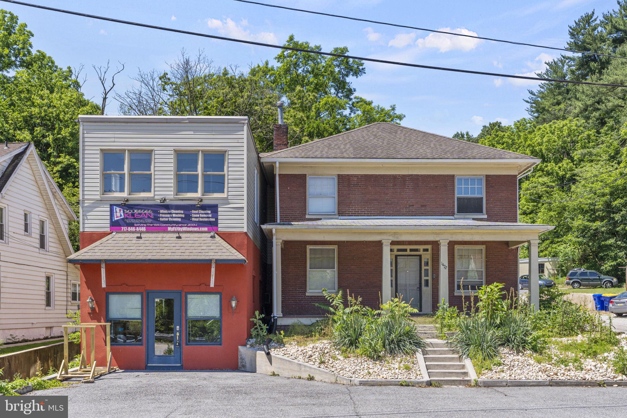 1422 S George St, an exceptional mixed-use property offering a unique blend of commercial and residential opportunities. This property comprises two main buildings: a fully renovated, 2-story commercial space currently utilized as an office for a service business, and a charming 3-bedroom brick home with an updated kitchen and ample character. The commercial building is ideal for a new business seeking a professional and ready-to-use space, while the adjacent residence is perfect for rental purposes or for those who desire the convenience of living and working on the same property.
Additionally, the property features two detached garages accommodating three cars, a covered front porch, a back deck, and extensive paved space providing ample onsite parking. Situated on S George St, this property enjoys close proximity to York Hospital, York College of Pennsylvania, Downtown York, and numerous national and regional employers, making it a prime location for both business and residential purposes. This versatile property is an excellent investment opportunity, offering the perfect balance of professional and personal space.