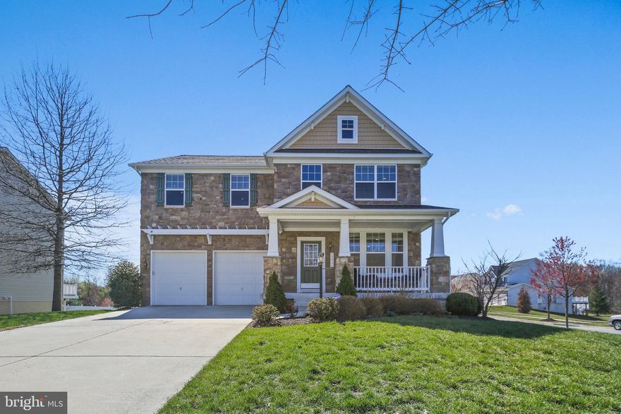 Located on a prime corner lot, beautifully maintained and thoughtfully upgraded, this 5-bedroom, 3.5-bathroom home in the highly sought-after Dixon Crossing offers an exceptional blend of space, style, and updates.

From the moment you arrive, you'll be captivated by the home's stone front and charming front porch, perfect for relaxing and enjoying the neighborhood. Step inside to find an inviting open-concept layout with gleaming hardwood floors and abundant natural light.

The gourmet kitchen is a chef’s dream, featuring sleek black quartz countertops, a stylish tile backsplash, stainless steel appliances, and ample cabinetry for storage. A spacious family room with a cozy fireplace flows seamlessly from the kitchen, making it ideal for gatherings.

The 6-foot bump-out on all three levels expands the living space, enhancing the family room, the luxurious primary suite, generously sized second bedroom, and lower level. The primary suite boasts a spa-like en-suite bathroom with a soaking tub, separate shower, dual vanities, and a huge (15' X 10') walk-in closet.

The lower level with walk up stairs to rear yard offers incredible versatility, featuring a 5th bedroom (w/ egress), a full bathroom, a spacious recreation area, and ample storage.

Other recent updates include a new roof (2023), paint, carpet, and lighting on the main and upper levels (2023), basement paint, carpet, and lighting (2021), and a new AC system (2021).

Ideally located near shopping, dining, and major commuter routes, this home is a true gem in an unbeatable location. Don’t miss this incredible opportunity!