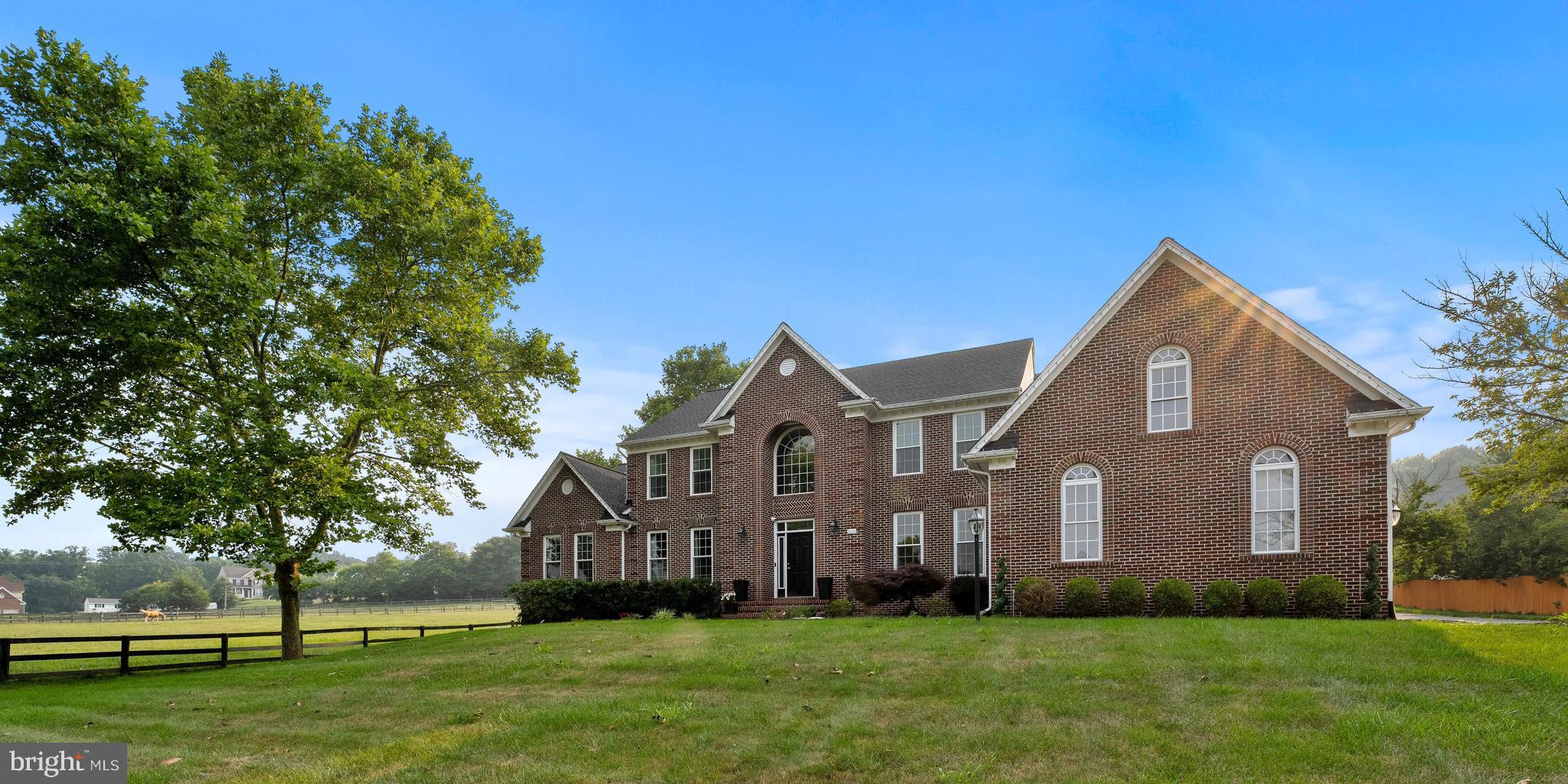 Welcome to this exquisite luxury home that combines elegance, comfort, and functionality to create the ultimate living experience! Nestled in the prestigious Woodford's Grant community, this residence boasts six spacious bedrooms, including two primary suites, offering unparalleled privacy and luxury.
As you step inside, you're greeted by a 2-story grand foyer that sets the tone for the opulent living spaces beyond. The first-level primary suite, thoughtfully designed with its own entrance, serves as a versatile space perfect for multi-family living or guest/au pair quarters. It provides a private retreat complete with a full bathroom, and its own spacious living/lounging area, ensuring comfort and convenience.
The heart of this home is its gourmet kitchen, a culinary enthusiast's dream come true! Equipped with double wall ovens, top-of-the-line stainless steel appliances, including such amenities as a 6-burner cooktop w/ griddle and a pot filler, built-in microwave, warming drawer, and complete with a butler's pantry and beverage center, this kitchen effortlessly combines style and functionality. Whether you're hosting grand dinner parties or preparing an informal meal, this space is sure to impress. Adjacent to the gourmet kitchen is the beautiful recreation room with its super comfy lounge area and its wall of windows with a view to the lovely rear yard or the serenity of the neighboring horses.
Throughout this home, ample room abounds, providing a harmonious balance between open communal areas and cozy private nooks. The layout has been thoughtfully designed to accommodate both large gatherings and intimate moments. Every detail has been carefully considered, from the high ceilings and abundant natural light to the exquisite finishes that grace each room.
Outdoor living is seamlessly integrated into this luxury home, with multiple seating areas that invite you to relax and unwind. One of the outdoor spaces features a firepit, creating an enchanting ambiance for evening gatherings and adding warmth to chilly nights.
Retreat to the top-level primary suite, a haven of tranquility and indulgence. Pamper yourself in the spacious en-suite bathroom, featuring a sumptuous standalone tub where you can soak away the stresses of the day. Custom closets offer ample storage and organization options, ensuring your belongings are always elegantly displayed.
Descend into the lower level of this magnificent home, and you'll discover an entertainment haven that is sure to impress. The lower level is dedicated to leisure and recreation, offering a range of exceptional amenities. A state-of-the-art theater room awaits, inviting you to immerse yourself in the latest blockbusters or enjoy a private screening of your favorite films. Adjacent to the theater, a large bar beckons, perfect for hosting gatherings and socializing with friends and family. The game room provides endless hours of fun, with options for table games, arcade games, or other exciting activities. A spacious living area offers a cozy retreat for relaxation and conversation, while a well-equipped workout room allows you to stay active without leaving the comforts of home. The lower level is an entertainment paradise that ensures endless enjoyment and creates lasting memories for all who enter.
This luxury home represents the epitome of refined living, where every detail has been meticulously curated for the most discerning homeowners. With its exceptional design, high-end amenities, and a perfect blend of indoor and outdoor spaces, this residence offers an unparalleled lifestyle for those seeking the very best!