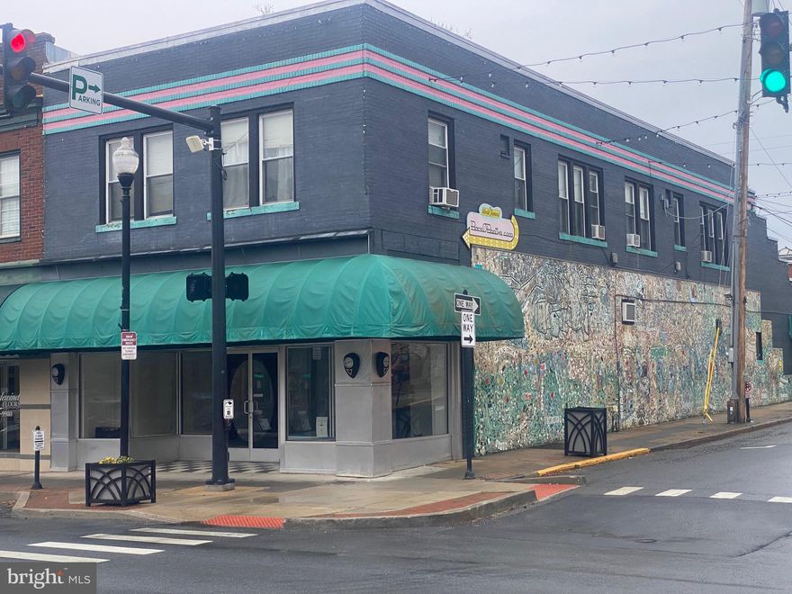 This landmark building is nestled in the heart of downtown Charles Town. Built at the turn of the century, it  offers sound brick construction and a great corner location (Washington St. and Charles St), affording excellent visibility for your business. Inside, the lower level is currently an open concept of 4236 sq ft. It can be made to suit your needs whatever they may be! The space features two handicapped accessible bathrooms and two additional street-side doors for deliveries. Upstairs you'll find two residential rentals that have remained steadily rented over the years! Finally, Charles Street side boasts the beautiful City of Charles Town Charles Street Mosaic Mural. This is a destination that guarantees traffic to your store front. This property is a rare find! Call for your showing today!