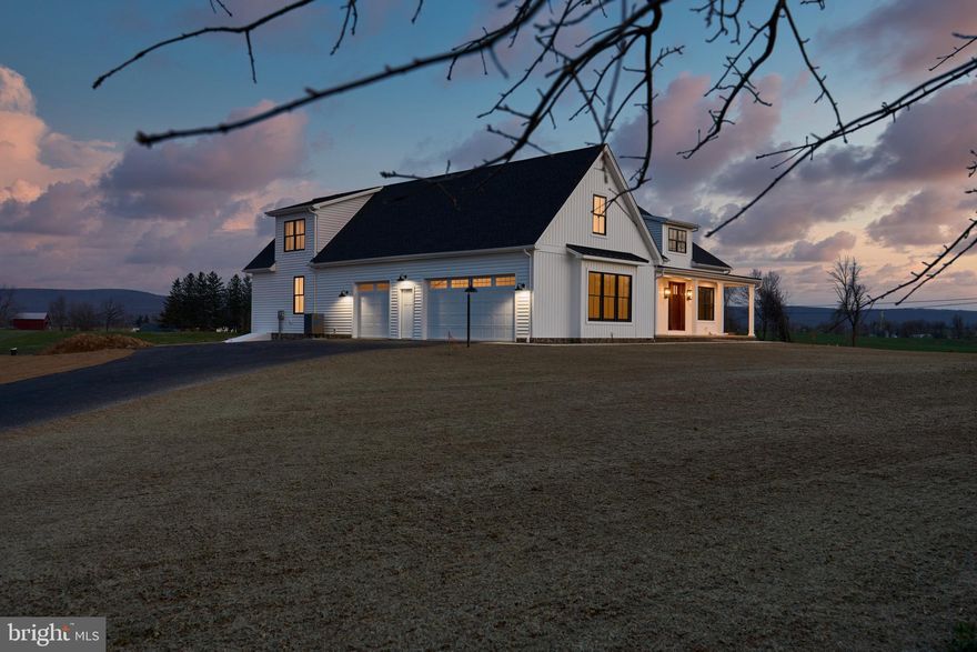 1 Peyton Drive is a less-than-four-year-old highly upgraded modern-farmhouse estate sitting on 2.43 acres in the beautiful Lindenwood community. Situated at the highest point in the community, 1 Peyton affords one-of-a-kind panoramic views of the Cumberland Valley.
 
At the end of the extended driveway, find an oversized 2 1/2 car garage- complete with 3 bays and a pedestrian door. Vertical and horizontal white siding contrasts against the black Andersen window package, and shed dormers accentuate the roofline with contemporary charm. Approach the front door and note the large covered porch, with sunset views to the west.

Step into the home via the 8-foot wooden door and your eye is drawn across the spacious foyer and living area to the picture-perfect view of South Mountain, framed by the 12-foot-wide Andersen Architectural Series Sliding Doors that access the rear covered porch. An open dining room to your left is framed by stained wood beams along the 9-foot ceilings and a wood column extending from the floor. Take in the living room’s 15-foot-tall cathedral ceiling- complete with a wood-stained ridge beam and ten auxiliary stained beams- that continues through the kitchen to your left. To your right is hall access to the guest wing, complete with two additional bedrooms, walk-in closets, linen closet, and a full bath.
 
Centered on the righthand wall of the living room is a fieldstone propane fireplace with a stained wood mantle. On each side of the fireplace are built-in shelves finished in shiplap which further accentuate the space. Looking out onto the covered porch, notice its stained wood ceiling, on which 2 exterior ceiling fans are mounted, in addition to dimmable recessed lights (the home features 55 dimmable recessed lights in total).
 
Take in the kitchen to the left, and note the white farm sink and stainless-steel Bosch appliance package- including double wall ovens (one being a speed oven), a 6-burner propane range, a range hood with shiplap accented chase, dishwasher, and refrigerator. The kitchen island and countertops are topped with a high-end granite, and high grade extended height wall cabinetry surrounds the space. A pocket door conceals the butler’s pantry, which features a wraparound countertop and abundance of outlets for appliances, high grade two-tone cabinetry, a built-in ice maker, and a window.
 
Continuing through the home into the primary suite, you pass a powder room and separate laundry to your left and an Andersen exterior hinge door to your right, providing easy access to the rear porch. Once in the primary you can appreciate the size of the space, as well as the size of the 9-foot by 10-foot walk in closet. Turning the corner into the primary bath, your eye is met with a stunning, doorless, walk-in custom tile and glass shower. 2 individual vanities provide separate sinks, and an extended countertop and makeup vanity provides room for a chair if desired.
  
Returning through the master wing, straight ahead is garage access, and a mud area with cubbies and finished in shiplap. Around the corner is access to the full Superior Walls basement, which features 9-foot ceilings, outside access, and a daylight window. To your right is a custom “Y” staircase with stained oak treads and painted white risers, which continues up to a landing and splits to the left and right. To the left is a massive bonus room (note the thermostat controlling 1 of 3 heating and cooling zones in the home’s energy efficient dual-fuel heat system), and to the right is a stained wood barn door. Open the door to reveal a stunning office or 4th bedroom, complete with another Andersen slider accessing the custom wrought iron balcony that offers sweeping sunlit views of the valley and mountains. To your left, a double window provides mountain views, and a full bath and closet complete the space. Built in 2022 by award winning local custom home builders Hutch Homes and Artisans Design Build.