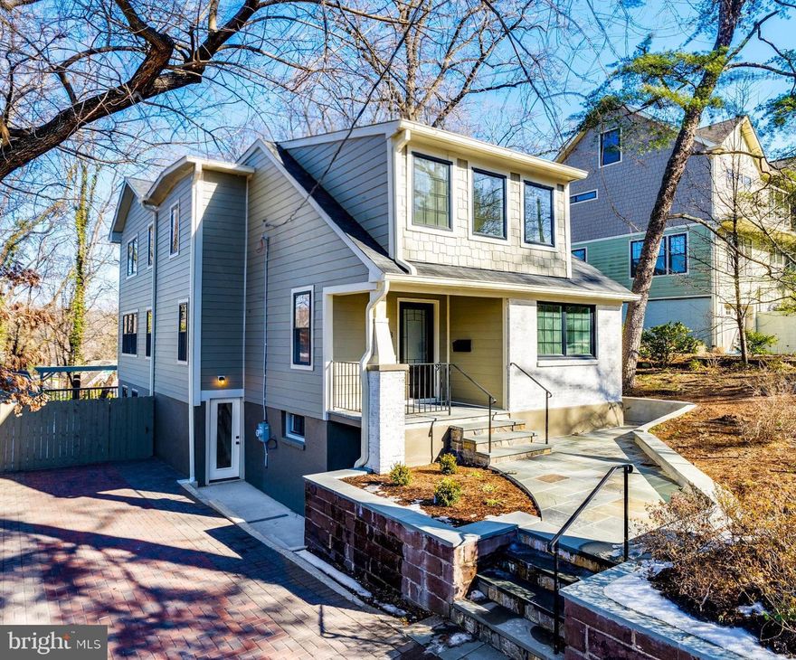 Welcome to 6513 Westmoreland Avenue, an enchanting, fully renovated bungalow blending earthy modern design with timeless charm in the highly sought-after Takoma Park. This remarkable five-bedroom, four-bathroom home boasts stunning architectural details, including new wood flooring, intricate herringbone tile accents, new sleek black Crittall-style windows, gorgeous fixtures, recessed lighting, and exceptional outdoor spaces.

The inviting front patio leads to a covered entry and a welcoming foyer with a convenient coat closet. Just off the foyer, a versatile office/bedroom features designer wallpaper on the ceiling and an adjacent, beautifully appointed full bathroom with natural slate wall tiles. Down the hall, a sun-filled great room – the heart of the home – offers abundant space for both dining and living. The chef's dream kitchen features quartz countertops, a stainless-steel appliance suite, elegant Shaker cabinetry, and a large center island, opening to the dining area and living space with walls of windows and access to the rear pergola and covered side deck.
The second level hosts three bright bedrooms and two beautifully-crafted full bathrooms, each with double vanities. The captivating primary suite showcases treetop views, recessed lighting, and a voluminous walk-in closet. The luxurious primary spa bathroom features tongue-and-groove tile work, a stunning vanity with double sinks, and an oversized walk-in shower. One of the secondary bedrooms includes a charming play nook and vaulted ceilings, and the upper level is complete with a laundry closet and linen storage.
The walk-out lower level offers a recreation room with great natural light, recessed lighting, a wet bar / mini kitchenette, an additional bedroom, a bonus room, a full bathroom, storage, and multiple entrances with access to the driveway and a fabulous pergola area.
Outside, the expansive 9,450-square-foot lot is brimming with mature plantings and offers a front patio, covered side deck, rear terrace with pergola, a long private driveway, a shed, and plenty of space to play. The home’s exterior is beautifully clad in Hardie plank and brick.
Enjoy the best of eclectic Takoma Park with a warm, tight-knit community and convenient access to shopping, dining, and entertainment. This home is located just over half a mile from the Red Line Metro, and blocks from the Farmer’s Market, Takoma Beverage Company, Busboys and Poets, Old Takoma Ace Hardware, Cielo Rojo, and Takoma Urban Park. With events like summer block parties, Halloween gatherings, and a Turkey Fry, this is easy, convenient living at its best!