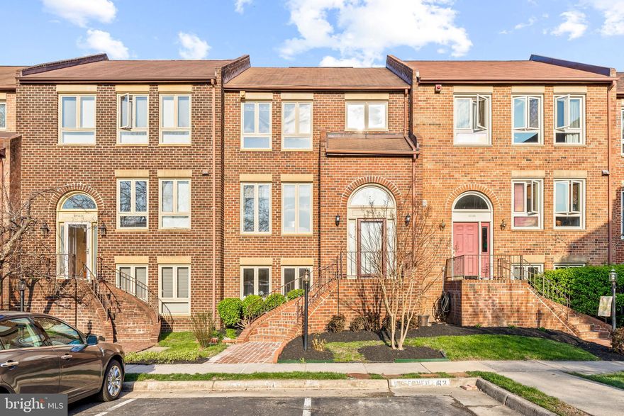 LARGE brick townhome with three finished levels ! Lots of windows offering tons of natural light! GLEAMING wood floors throughout main and upper level! Updates include granite counters in the kitchen, crown molding and chair railing, and fresh neutral paint! Master bedroom with walk-in closet and en-suite bathroom featuring dual vanities. Finished basement boasts bedroom, full bathroom, large laundry room, and spacious family room with fireplace, wet bar, and walkout to private patio backing to green space.