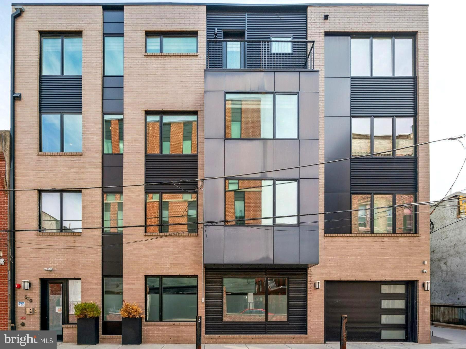 This contemporary 3-bedroom, 3.5-bathroom residence offers the perfect blend of luxury, functionality, and location—nestled in the highly desirable Meredith School Catchment with Garage Parking, a Private Roof Deck, and over 1,800+ square feet of beautifully designed living space. Tucked into a quiet block in the heart of Queen Village, this like-new construction condo is flooded with natural light and thoughtfully laid out over two spacious levels. The main floor features a wide-open living and dining area ideal for everyday living and entertaining, plus a guest bedroom and full bath, offering flexible living or work-from-home space. The modern kitchen boasts a stainless steel Bertazzoni appliance package and ample storage and prep area, while seamlessly connecting to the rest of the home for effortless flow, there is also a convenient powder room on this level. Upstairs, retreat to a tranquil Primary Suite complete with an ensuite bath, 2 large walk-in closets, and privacy from the rest of the home. A third bedroom and additional bathroom are located on this level. Atop it all, the private Roof Deck offers panoramic skyline views, perfect for relaxing or hosting under the stars. This home also includes an oversized one-car garage space with interior access and bike storage. Once outside you're just steps to everything Queen Village has to offer, along with lots of parks & green space. And with a 99 Walk Score its easy to walk to everything—cafes, dining, boutiques, and markets. Plus, with quick access to I-95, major bridges, and Center City, commuting is simple. 3 years remaining on the full 10 year tax abatement and low monthly condo fees.