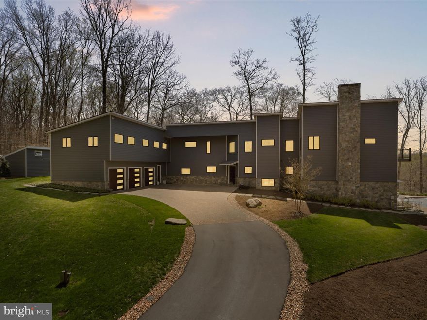 Spectacular one of a kind custom built  L shaped contemporary of hardy plank and stone with a 2 story exterior stone fireplace, paver driveway sitting on 5 private acres on 1000+ ft of the Occoquan River with views both north and south!  8000 sq ft 5 bedrooms, 5.55 baths, 3 levels facing west with scenic vistas from all the living space plus 3 of 5  bedrooms! 3 car garage. Above the garage is a bedroom suite/inlaw suite/aupair suite w a convenience bar( possible partial kitchen and full bath  as a wing to the gorgeous contemporary!  High ceiling ( 9/12/14 feet high) and  open  floor plan!   Oversized double door solid wood entry to 2 story foyer. Elevato to all 3 levels,  deep coat closet, open offset metal staircase with wooden handrails to both the upper and lower level, plus second staircase! Huge full wall, floor to ceiling windows w UV protection! 3 fireplaces ( 2 gas, 1 wood)- ll rec room, great room and master bedroom! Main level foyer entry, huge living room, separate dining room with  butlers pantry/bar and deck access plus 2 half baths at either end of the main level. HUGE great room open to kitchen, island, customized cabinetry with quartz counter top luxury  SS appliances including subzero with front  window,  under the counter microwave, euro styled double wall ovens, euro styled gas downdraft  5 burner cook top, pocket handle dishwasher! Views from all room gorgeous but the great room overlooks the inground pool, pool house and the river! Gas fireplace and a wall of windows! Deck access from the great room with steps down to the pool! Magnificent stone steps down to the river and private dock.  Upper level of main space has huge bedrooms, 3 with a balcony and a private ensuite bath with quartz vanity tops, custom glass shower doors and heated floors. The primary bedroom has a sitting area, gas fireplace,  walk in closet and double closets, baloney overlooking the river and the pool plus a glorious primary bathroom with a separate soaking tub with scenic views, separate glass enclosed shower, private toilet and bidet. Gorgeous hardwood floors on two levels! Lower level features a stone wood burning fireplace, wall of windows with access to the  pool and pool house plus an impressively organized utility room, wine cellar room and full bath! Heated floors, beautiful recessed and custom lighting ( the natural light is incredible).  Whole house generator, good for 7 days!  The pool will have an automatic cover, winter cover, heater and is self cleaning and features aa dual water fountain in the shallow area for lounging! The pool house opens completely to the deck with a partial kitchen and full bath! SO much to LOVE. Please note the county described the quality as SUPERIOR!