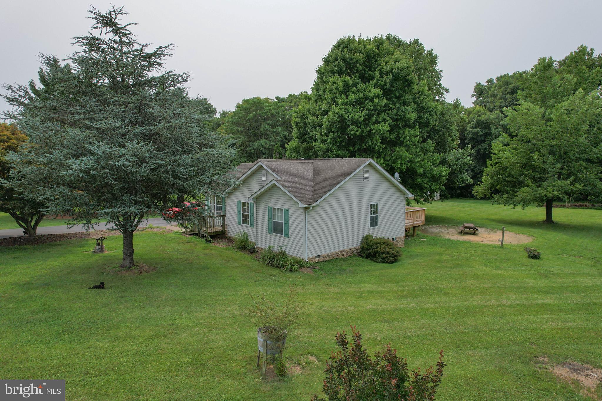 This adorable 3BR/ 2BA rancher on over an ACRE in a park like setting will not last long! Your chance for homeownership is here and awaits in beautiful Bunker HIll, WV. You will love the big oak tree shade, the large decks, the sun room and the low maintenance layout and size of this perfect rancher!