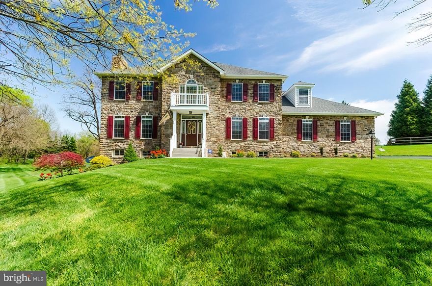 Spectacular, single owner, custom home in a quiet neighborhood showing a high level of craftsmanship inside and out.  Perfectly sited on a 2+ acre lot, this stone front 4 bedroom colonial is a standout.  Enjoy the rolling hills from the enormous deck with dining space and room for the fire pit and outdoor furniture.  Inside, hardwood floors travel through the main floor and shine through the oversized windows and transoms, creating bright and inviting living spaces.  Beautiful natural hardwood cabinets set on top of a ceramic floor in the quaint country kitchen and adjoining breakfast room which serve as the heart of the home, surrounded by separate living, family, and dining rooms.  Get your work done from home with high speed cable internet available and a professional office/study with custom built-ins which will make the ultimate backdrop.  Peace and relaxation lies upstairs in the primary bedroom and en suite bathroom with a jetted soaking tub, separate floating glass shower, separated dual vanities, and large walk-in closet.  The three other large bedrooms upstairs provide plenty of space and character, sharing a large bathroom with dual vanity.  If you're still in need of more space, there is a massive unfinished, walkout basement which provides a great area to build equity or additional storage.  Home features a whole house generator system, tankless hot water system, water softener, and a leased 500 gallon buried propane tank.  Seller is offering a one year home warranty upon request.