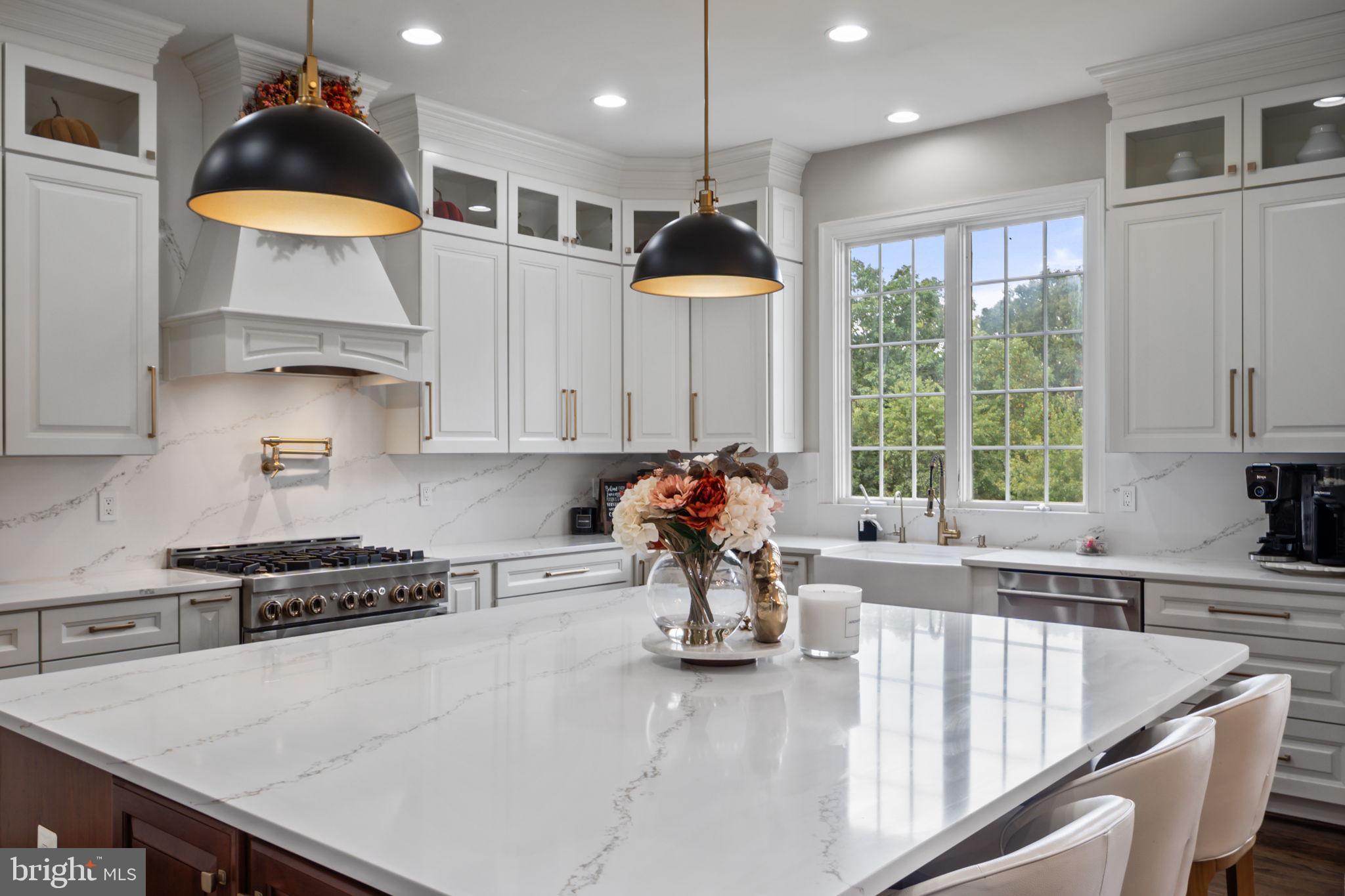 ✨ Luxury Redefined in Ijamsville – 11162 Innsbrook Ct ✨
Discover timeless elegance and modern sophistication in this extraordinary residence, perfectly situated on a quiet cul-de-sac in one of Ijamsville’s most prestigious communities. This home seamlessly blends high-end finishes, thoughtful updates, and the ideal balance of privacy and convenience.
As you step into the inviting two-story foyer, a comfortable living room greets you on the right while a formal dining room graces the left. Moving forward, you’ll find a spacious family room anchored by a cozy fireplace, with a private office to the side—currently used as a children’s playroom. A stylish powder room is conveniently located nearby, and just beyond sits a charming coffee and bar area with a beverage fridge. From here, the home opens into the heart of the property: a breathtaking gourmet kitchen.
This brand-new kitchen is designed for both function and beauty, featuring quartz countertops, an oversized island, high-end JennAir appliances, a farmhouse sink, and a custom bar cabinet with beverage cooler. Soaring ten-foot ceilings and abundant natural light highlight the refinished hardwood floors, while designer chandeliers add a touch of elegance to the main living spaces. The result is a warm, welcoming atmosphere—ideal for entertaining or enjoying quiet evenings at home.
Upstairs, four generously sized bedrooms provide comfort for the entire family, with new plush carpeting throughout. Two bedrooms share a convenient Jack and Jill bath, while another enjoys its own private bathroom. At the end of the hall, the laundry room offers direct access to a secondary staircase that leads down to the kitchen. The luxurious primary suite is a true retreat, with a tray ceiling, an adjoining sitting room currently used as a home office, and two expansive walk-in closets. The spa-inspired bathroom features modern finishes, a second tray ceiling, and a serene design. Every detail has been thoughtfully considered, from new stair railings with wrought iron balusters to antique black hardware, electronic door locks, and beautifully updated bathrooms. Even the toilets have been upgraded with bidet functions for added comfort.
The finished basement expands the home’s versatility with a second fireplace, soaring ceilings, and an open layout that can serve as a home theater, gym, or guest suite. A spacious bedroom and full bathroom make it ideal for in-laws or long-term visitors, and rough-in plumbing provides the option to add a wet bar or kitchenette in the future.
Outdoors, the beautifully landscaped and fully fenced backyard offers a spacious deck—perfect for summer barbecues, morning coffee, or simply unwinding at the end of the day. The property’s appeal is enhanced by its location in a sought-after community featuring a pool, playgrounds, tennis courts, and basketball courts.
With its new gourmet kitchen, refinished hardwood floors, updated baths, high ceilings, and prime location just minutes from top-rated schools, major commuter routes, shopping, and dining, 11162 Innsbrook Ct is a rare gem that perfectly combines luxury, comfort, and convenience. This is more than a home—it’s a lifestyle.
👉 Schedule your private tour today and experience the unmatched elegance of 11162 Innsbrook Ct.