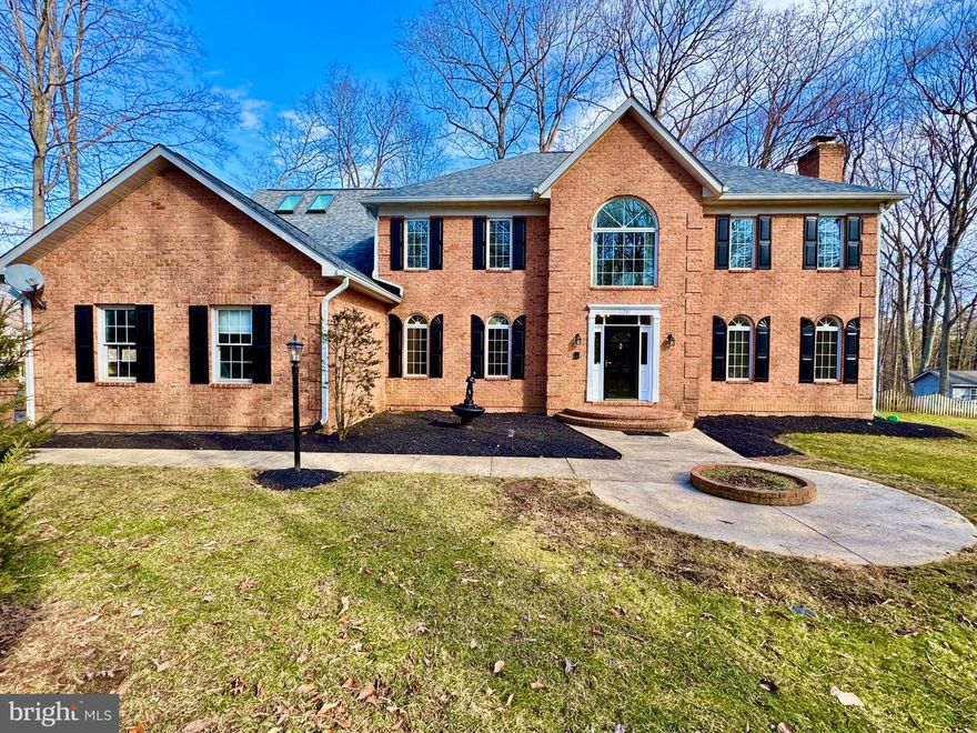 Discover unparalleled luxury in this stunning home nestled on 2 ¼ wooded acres, offering a private retreat while being just minutes from Prince William Parkway, top-rated schools, shopping, dining, and major commuter routes. NO HOA (Architectural Control Committee governs exterior aesthetics), this home truly offers something for everyone. 
Inside, you'll find spacious rooms, an elegant hardwood foyer, and a gourmet kitchen with cherry cabinets, a large island, instant hot water, and a picturesque window overlooking the serene backyard and deck. Natural light floods the home throughout, enhancing its spacious and inviting atmosphere. A Butler’s Pantry/wet bar connects the kitchen to the formal dining room, while the eat-in kitchen flows into an extra-large family room with a floor-to-ceiling fireplace and double doors leading to the deck, making entertaining a breeze. The main-level home office off the foyer is perfect for remote work. 
Upstairs, four charming bedrooms provide cozy comfort, with one featuring a beautiful bay window that frames stunning outdoor views. Every space is thoughtfully designed to maximize light and elegance. The massive master suite is a true retreat, featuring a private sitting area with skylights, perfect for relaxation. The en-suite bathroom offers a spa-like experience with skylights. Infrared sauna lighting in both bathrooms upstairs create an ambiance of tranquility.
This estate boasts a brand-new, fully finished walkout basement, thoughtfully crafted for modern living with limitless potential. Featuring a stylish wet bar with a beverage cooler, new white cabinets, a sleek sink, an elegant backsplash, and a built-in wine rack, this space exudes an upscale charm.
Additionally, the basement features an upgraded bathroom, a newly finished bedroom, along with one additional room and endless possibilities. The cozy brick fireplace in the basement living area adds warmth and character, while the new electric fireplaces in both bedrooms create an inviting ambiance. Whether you envision a private guest suite, media room, home theater, or recreation space, this versatile lower level is ready to be customized to your lifestyle. With direct outdoor access, natural light, and top-tier finishes, this exceptional basement is the perfect compliment to this stunning luxury estate.
Tucked away in a peaceful setting, this home offers a breathtaking backyard sanctuary, a gardener’s delight! A grand driveway welcomes you to this distinguished residence, offering both sophistication and convenience with an oversized three-car garage. This exceptional property is a rare find—secluded yet convenient, offering privacy, space, and timeless luxury.
Experience the pinnacle of luxury living and schedule your private showing today!