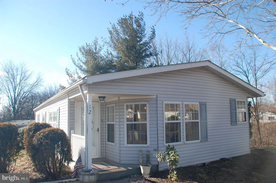 What’s even better than a great location?  A great house in a great location!  Located on the preferred outer rim of the popular Hidden Springs 55+ community, you will love the 20’ x 11’ deck with a terrific view of the contiguous wooded open space.  There’s lots to love inside too.  Don't miss the Floor Plan included with this listings!  The Primary BR Bath and Hall Bath were completely renovated in 2024.  The Primary Bath features a new 4’ stall shower and two separate vanities with Corian tops. No fighting for space in this oversized Bathroom!  Built-in bench seat and LVP flooring.  The Hall Bath has a new vanity and new tub/shower unit that has never been used!  The entire interior of the house was just repainted, including the ceilings, except for the Bathrooms and Laundry Room that were painted as part of the renovations in 2024.  There is an abundance of counter and cabinet space in the Kitchen, including a pantry cabinet with canned good storage on the doors.  The carpeting was just professionally cleaned and the entire house has been cleaned from stem to stern.  Home Inspection repairs completed:  GFCI receptacles installed in Laundry Room, loose plumbing vent collar on roof secured, vinyl trim at exterior door repaired, loose exterior faucet secured, condenser unit leveled, flex duct elevated off crawl space floor, loose electrical wire in crawl space secured, vapor barrier installed where missing and appropriate vapor barrier installed where needed in crawl space, certain fogged glass in some windows has been or will be replaced by Alderfer Glass, new dishwasher installed.  This house is move-in ready.  Come check it out.  You won’t be disappointed!