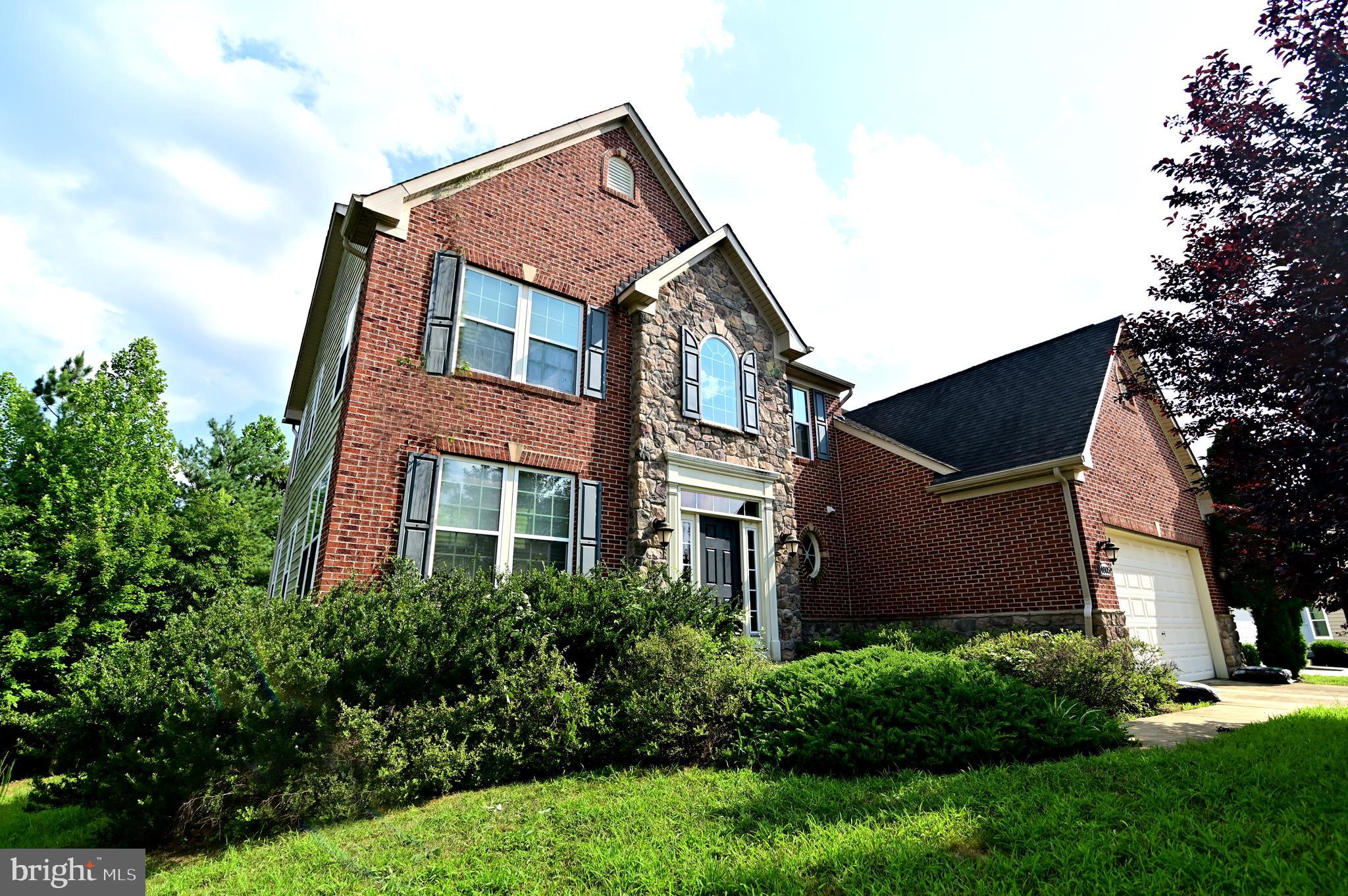 Home Sweet Home! This beauty is tucked in rear of a round-about with plenty of driveway parking for 4 in addition to the 2 car garage, pruned landscaping, brick, stone and vinyl exterior and deck for outside entertaining. Step inside and take a look at the wood floors in the foyer with wood and carpet floors leading upstairs. There's plenty of entertainment space with a living and dining room combination, adequate kitchen with granite counters with island eating space, rear sunroom for more dining or relaxing opportunities and a family room with fireplace. The owner's suite has the works with dual walk-in closets, luxury bathroom and plenty of storage. The remaining 3 bedrooms share a full bathroom. Title work has begun and seller prefers Cardinal Title Group.