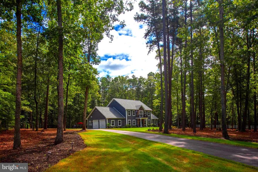 Nestled within the exclusive Honor Bridge estate section of the prestigious, gated Fawn Lake community, this nearly new exquisite coastal-style residence offers an unparalleled blend of luxury and tranquility. Spanning 3.43 acres, this property is a true sanctuary, boasting a stunning backdrop of lush trees and a serene pond with koi and elegant fountains, perfect for those seeking a peaceful retreat. As you approach the home, the elegant HardiPlank and stone exterior exudes sophistication. The side-entry garage provides both convenience and aesthetic appeal, while the driveway leads you to the grand entrance. An underground irrigation system draws from a private well, providing efficient and sustainable watering for the landscape. Step inside to discover an open floor plan that seamlessly integrates elegance and functionality. The interior features rich hardwood flooring, accentuated by recessed lighting that creates a warm and inviting ambiance. The gourmet kitchen is a chef's dream, equipped with stainless steel appliances, including a built-in microwave, wall oven, and a spacious island with Quartz countertops, perfect for entertaining. The butler's pantry and ample cabinetry ensure that every culinary need is met with ease. The sunny breakfast area opens to a light filled family room with vaulted ceilings. The expansive living area, complete with a fireplace and mantel, invites relaxation and comfort, while large energy-efficient windows frame picturesque views of the pond and surrounding nature. Retreat to the luxurious main floor primary suite, featuring a walk-in closet and a spa-like bathroom with a soaking tub, offering a perfect escape after a long day. The beautiful open staircase leads to the upper level with four spacious bedrooms with walk in closets and 2 full baths. This home is not just a residence; it's a lifestyle. **In-ground pool to be constructed by seller. Tesla charger in garage and leaf guards have been added.  Experience the perfect blend of luxury, comfort, and community in this exceptional property, where every detail has been thoughtfully curated to enhance your living experience. Enjoy the best of both worlds with pond-side living on a private estate while enjoying the finest amenities that Fawn Lake has to offer. The Fawn Lake community provides an unparalleled luxury lifestyle with exceptional amenities, including gated 24 hr security, a recreational boating lake, sandy beach, community pool and clubhouse, renowned Arnold Palmer golf course, tennis and pickleball courts, soccer and baseball fields, miles of scenic walking trails, a dog park, marina, on-site restaurants, playgrounds, and a variety of clubs and activities for all ages. Experience the pinnacle of resort-style living, where every day feels like a vacation!