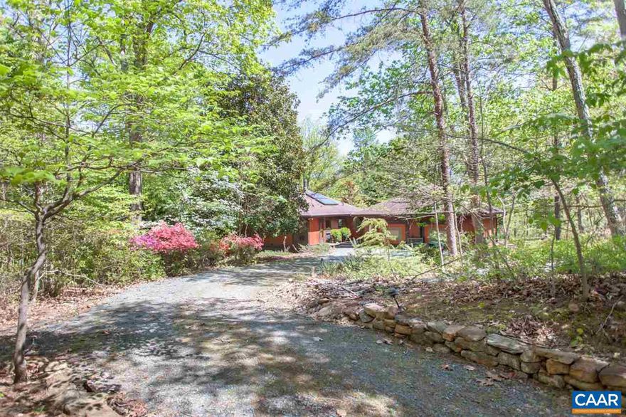 This mid-century late modern home features an abundance of light, privacy, & unique features throughout. Double windows & sliding doors allow natural light to fill the home. Enter the foyer & see a large center staircase leading to the spacious basement level family room with cast iron wood burning stove & yard access. On the main level, the large living room includes entrance to the custom Epay deck with a handmade wrought iron railing. This deck overlooks the dwarf conifer gardens ? beautifully landscaped & low maintenance with plants from around the world. This home includes a master bedroom suite with generous walk-in closet, garage workspace & more. Located close to Pantops, I-64, and all the amenities Charlottesville has to offer.,Wood Cabinets,Fireplace in Basement,Fireplace in Family Room