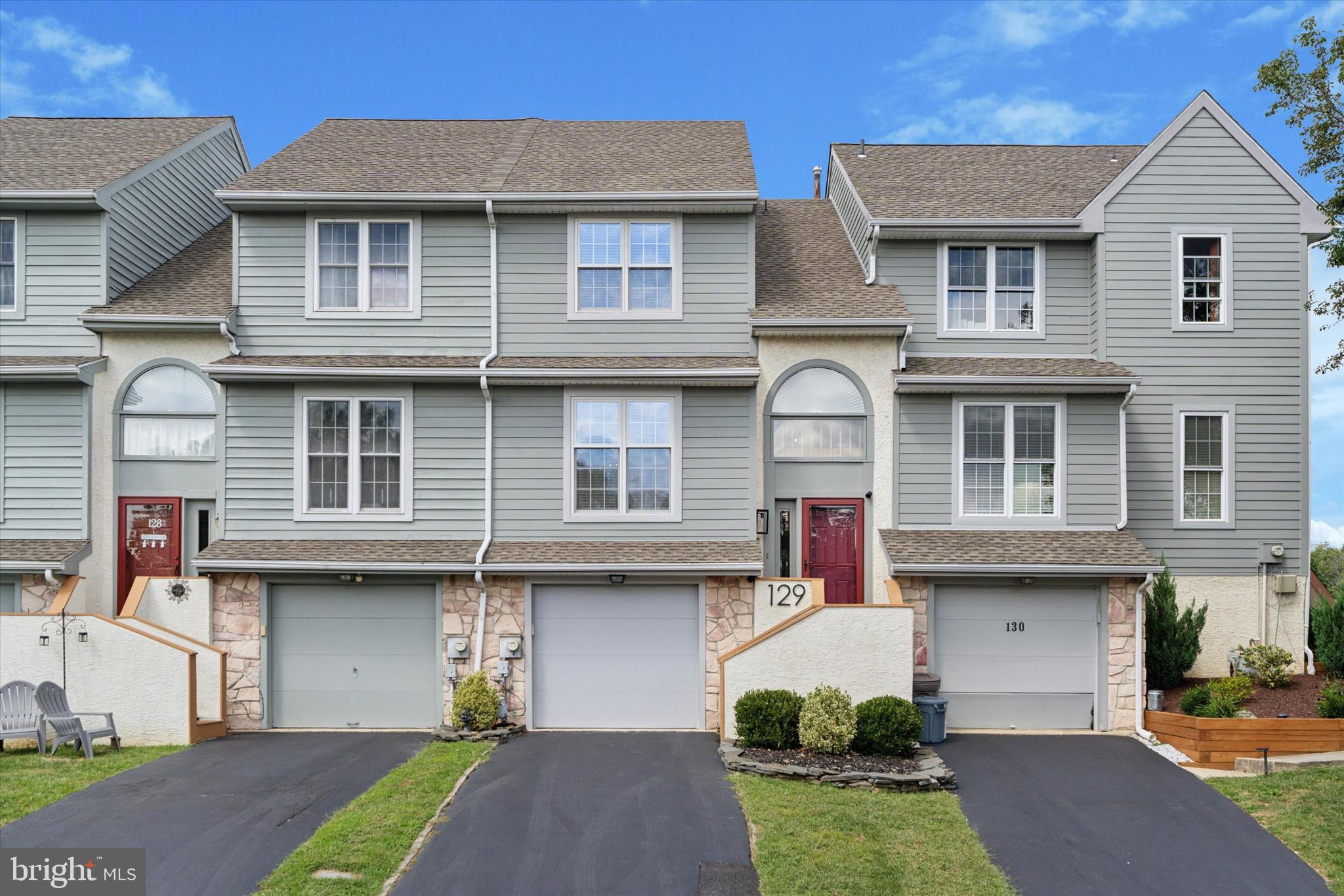 Welcome to 129 Knollwood Ct, a beautifully maintained 2-bedroom, 2.5-bath townhouse in the Ballinahinch community. From the moment you arrive, the private driveway and one-car oversized garage provide both practicality and extra storage space. Step inside to find gleaming hardwood floors that set the tone for the inviting interior. The main level showcases a sunken living room with two sliding glass doors that lead to the back deck. This layout floods the space with natural light while creating an ideal flow for entertaining or relaxing. The spacious dining area seamlessly connects the living room and kitchen, perfect for hosting gatherings. The kitchen features a brand-new backsplash, abundant granite counter space, crisp white cabinetry, a new microwave, stainless appliances and a pass-through window looking over the dining room. Step out onto the freshly painted back deck, complete with stairs down to the grass. Enjoy the weather all Fall season, where you can sip your morning coffee or unwind in the evening. Upstairs, new Brazilian cherry hardwood floors extend across the upper landing, hall, and primary bedroom. The primary suite boasts a walk-in closet and a private en-suite bathroom, while the additional bedroom offers a large double-door closet and easy access to the updated hall bath with fresh paint and modern fixtures. For added convenience, a laundry closet with a brand-new washer is also located on this level. The lower level adds even more versatility, offering a flexible den space perfect for a family room, office, gym, or hobby area. A powder room and interior access to the garage complete this level. The windows have custom blinds. Outside, the home features all-new James Hardie siding for peace of mind and curb appeal. Residents of this desirable community enjoy access to tennis courts and playgrounds. The location is unbeatable, just minutes from fantastic dining options, Rails to Trails for walking, biking, and running, and the ever-popular Linvilla Orchards for seasonal fun. Situated in the Penn-Delco School District with easy access to Rt. 1, Rt. 452, 476, and I-95, this home is a commuter’s dream. Don’t miss the opportunity to make this move-in-ready home yours. Schedule your appointment today! Home is where your story begins!