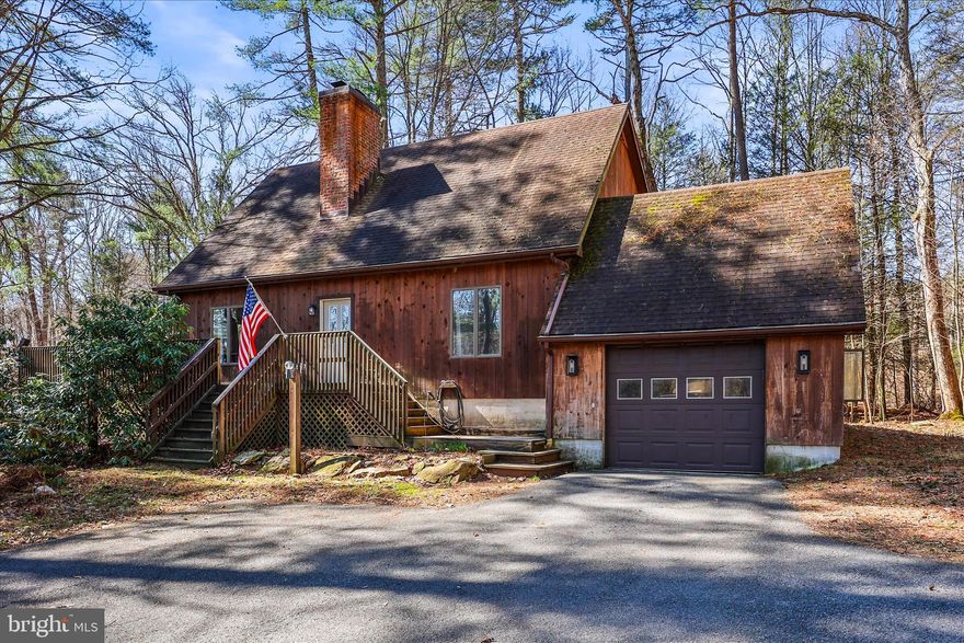 Welcome to 200 Boyds Hollow Road. Tucked away on 2.5 acres, this charming 3-bedroom, 3-bath two-story cabin style home offers the perfect blend of rustic character and modern comfort. Step inside to an inviting open-concept living room and kitchen, ideal for both everyday living and entertaining. Down the hall, you’ll find two well-appointed bedrooms featuring updated flooring, along with a full bath. Upstairs, a spacious loft overlooks the main living area and kitchen, offering a stunning vantage point and beautiful views. The primary suite is also located on this level, complete with a walk-in closet, a newly remodeled en-suite bath, and private access to its own balcony—perfect for enjoying peaceful mornings or quiet evenings. The fully finished basement expands your living space with a generously sized family room featuring a cozy wood stove and a wet bar. Right off the family room is a patio with a hot tub. This level also includes a versatile bonus room and a dedicated laundry area. Outside, a large deck provides breathtaking views of the surrounding landscape. A scenic trail winds through the property, leading to a workshop/barn, with a tranquil stream along the way—creating a serene, nature-filled retreat you’ll never want to leave.