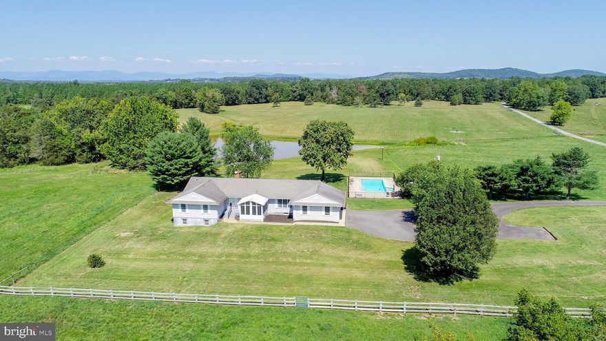 The "Fields of Plenty" farm presents a unique opportunity for those interested in agricultural ventures or seeking a serene lifestyle amidst nature. Spanning approximately 148 acres in the historic Rapidan, VA, this property is not only vast but also versatile, offering electric fencing for livestock, a paddock, and fertile hay fields. The main residence, constructed in 1990, boasts over 5000 square feet, complete with modern amenities such as an attached garage, workshop, and a concrete inground pool. The expansive outdoor living areas, including porches and a deck, provide panoramic views of the tranquil pond and lush pastures. Additionally, the estate features a second home, dating back to 1939, which adds to the charm with its own set of comforts, including a wraparound porch and a pergola set among mature shade trees. This property encapsulates the essence of country living while providing the facilities needed for a working farm or a private retreat. While all inspections are welcome the property is being sold as-is and any rollback taxes will be paid by the party taking the property out of Land Use. The house description in the MLS is that of the 1990s house.  There is a description of the 1939 house ( 4 BR, 2 BA) on file with the other information. The taxes accurately reflect the entire 4 parcels and both houses.