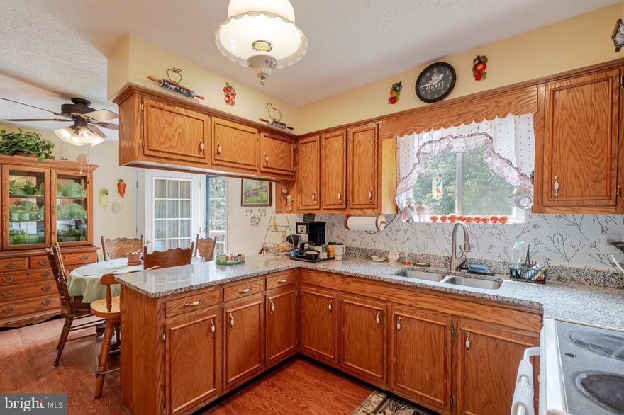 Nestled in the serene embrace of Massanutten Forest, this charming 2-bedroom, 1-bathroom residence offers a unique blend of convenience and privacy, perfect for those seeking a tranquil retreat. This detached home on 3.2 acres, showcases immaculate landscaping, complemented by a paved driveway and durable vinyl siding that enhance its curb appeal. This home has been meticulously maintained, with many recent energy saving updates including wrapping all pipes, adding new insulation in the attic and crawl space, and sealing all doors, windows, and vents. In addition, a new furnace, A/C unit, and thermostat were installed in 2025 and the roofs on the house and all out buildings were replaced. Step inside to discover a warm and inviting atmosphere, with wood flooring on the main living spaces, new granite in the kitchen, and recent bathroom updates. The proximity to the National Forest invites outdoor enthusiasts to explore hiking trails and wildlife, while public boat landings on the Shenandoah River are just minutes away for those water lovers. The expansive outdoor space provides endless possibilities for creating your own personal oasis, whether it be a garden, patio, or simply a peaceful retreat to enjoy the surrounding landscape. There is a wet weather stream on the back side of the property. This property could be a permanent home, vacation home, or income producing rental, as short term rentals are permitted in this subdivision. Luray Caverns is just 7 miles away and Main Street in Luray offers quaint shops as well as excellent food and drinks.