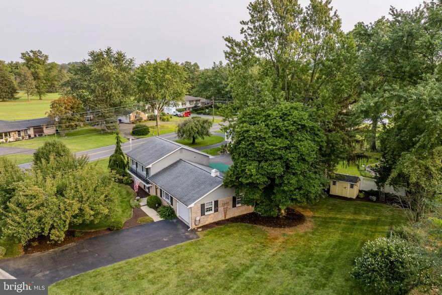 Welcome to 3714 Jonas Drive, a well-kept split-level home on a desirable corner lot on the outskirts of Landisville. This residence offers 1,871 square feet of living space. The main level features a sunny living room and an open kitchen and dining area with direct access to a shaded, covered patio and seasonal awning. The upper level includes 3 bedrooms and a full bathroom, while the lower level offers a family room, half bath, laundry/utility area, and a bonus room/potential 4th bedroom. Comfort is enhanced by radiant ceiling heat with a thermostat in each room, plus high-velocity central A/C serviced yearly. An attached heated garage and garden shed add storage and convenience. Washer, dryer, microwave, dishwasher, refrigerator, and stove are included. With easy access to Routes 283 and 30, this home combines small-town living with commuter-friendly convenience.