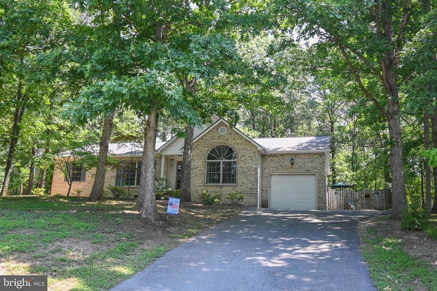 Lovely 3 bedroom 2 bath rancher nestled in on a 1.2 acre wooded lot.  Enjoy the shaded fenced in back yard, walking trail,  zip line, fire pit and much more.   This home is in wonderful condition including a new roof.  Close to the amenities of Inwood, Martinsburg and Charles Town makes this a very centralized location for our area.  The community boasts all large lots to give you some separation and privacy from your neighbors.  Come take a look to see if this is the one you've been looking for.